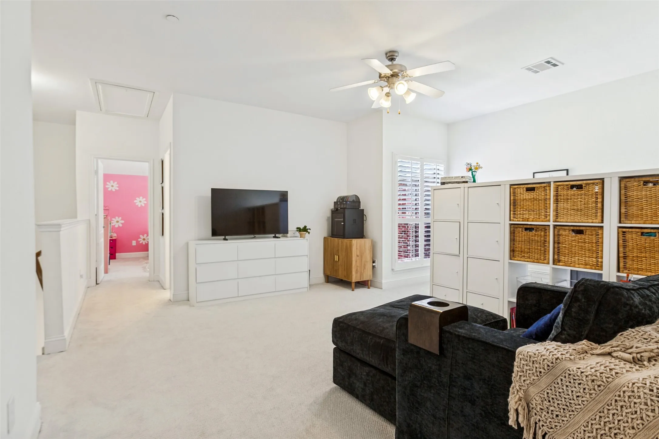 Large bonus room with potential for future 3rd bedroom, Carpeted flooring, ceiling fan, and window with plantation shutters. Great, office, gym, playroom etc