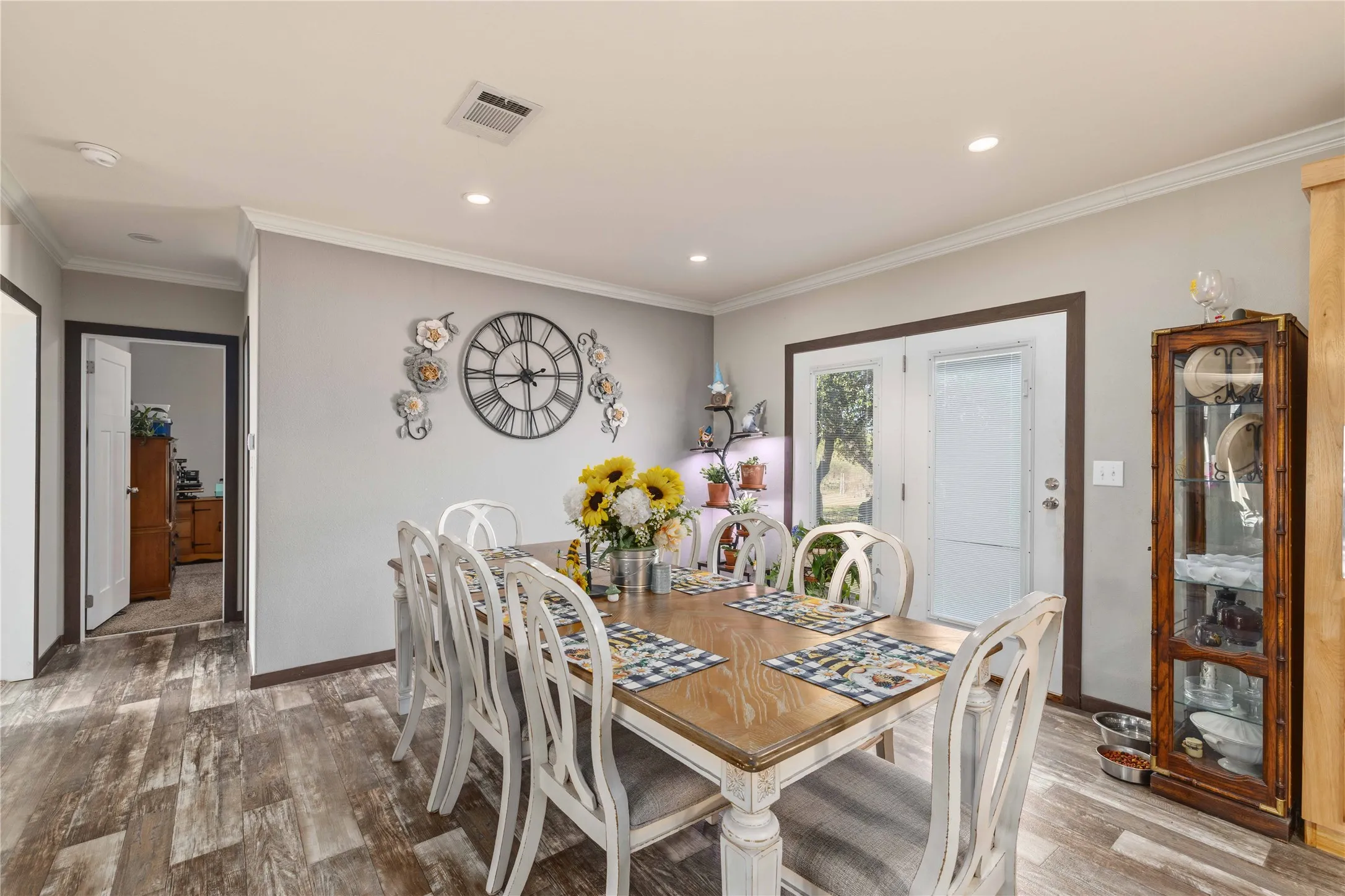 Wood-finish flooring with white crown molding
