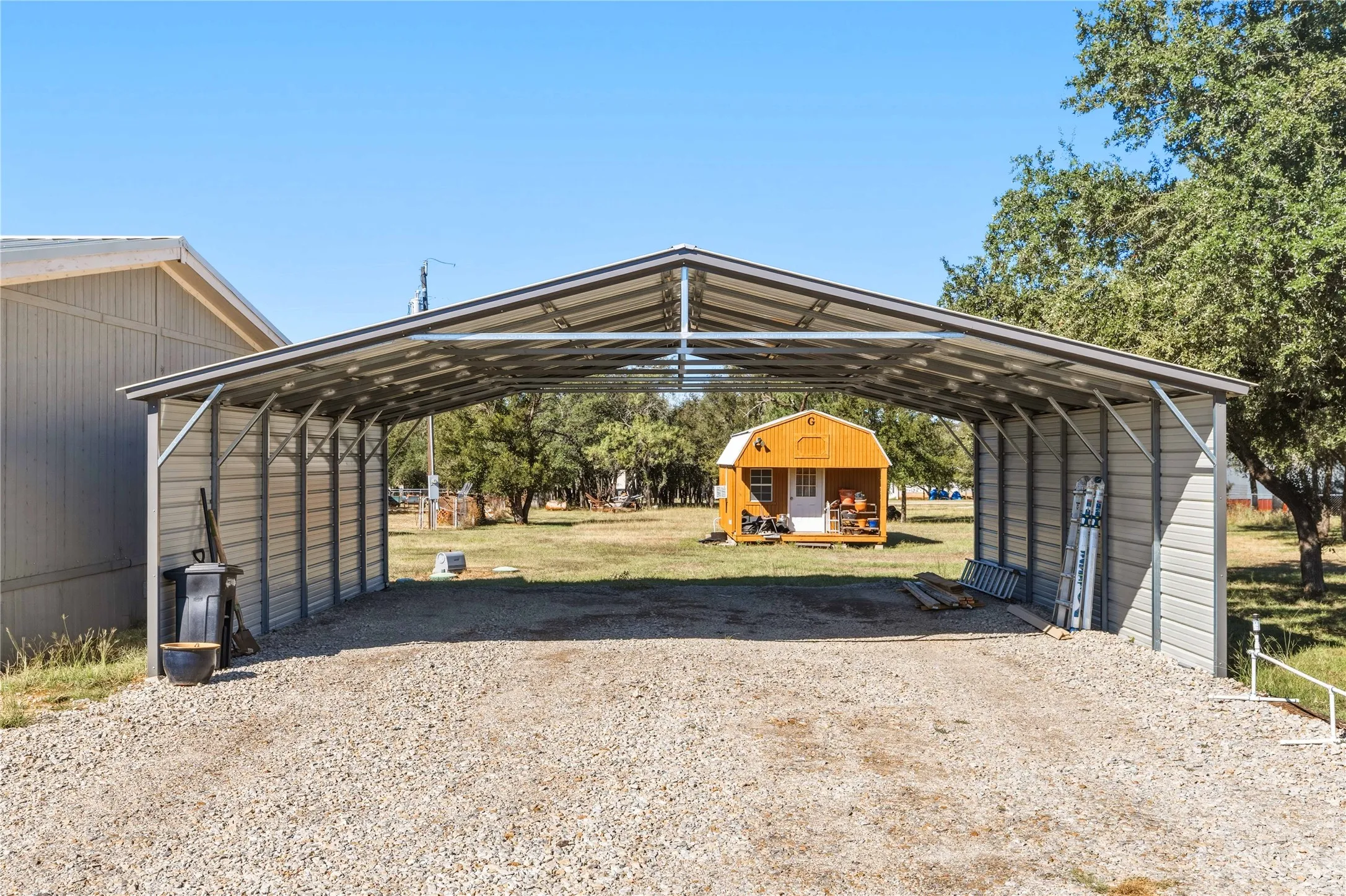 Attached metal carport with a gravel base