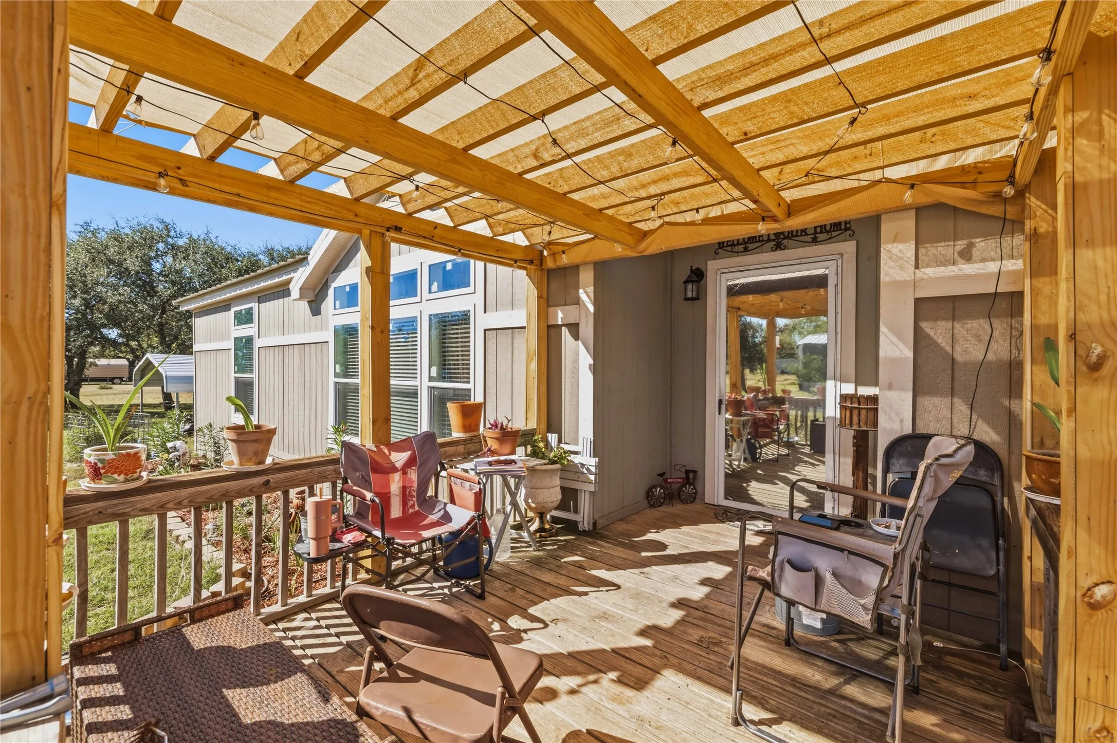 Wood-finish decking with a wooden railing and a partial shade structure