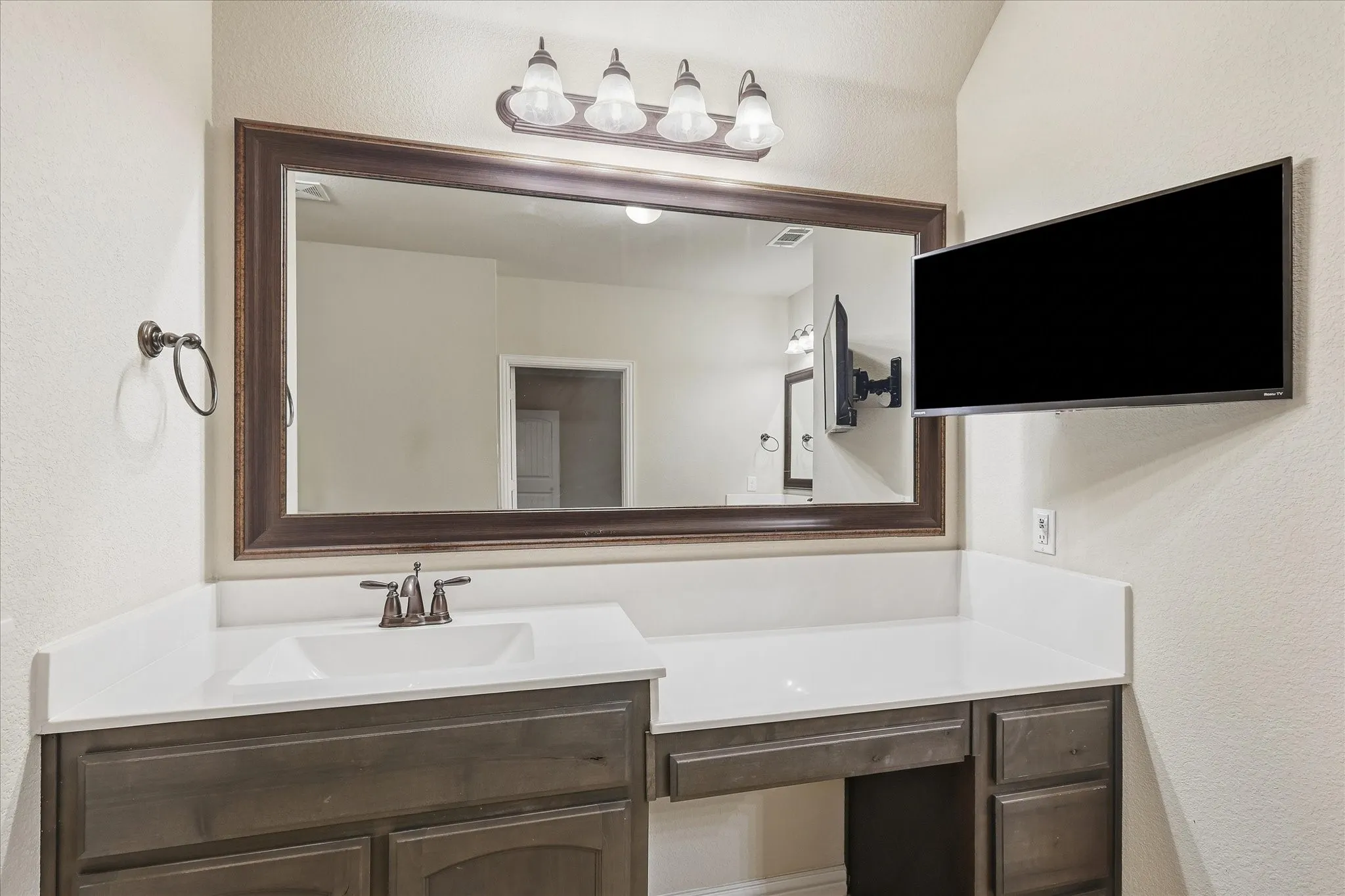 Vanity with a single sink, an undermount basin, and a bronze-finish faucet