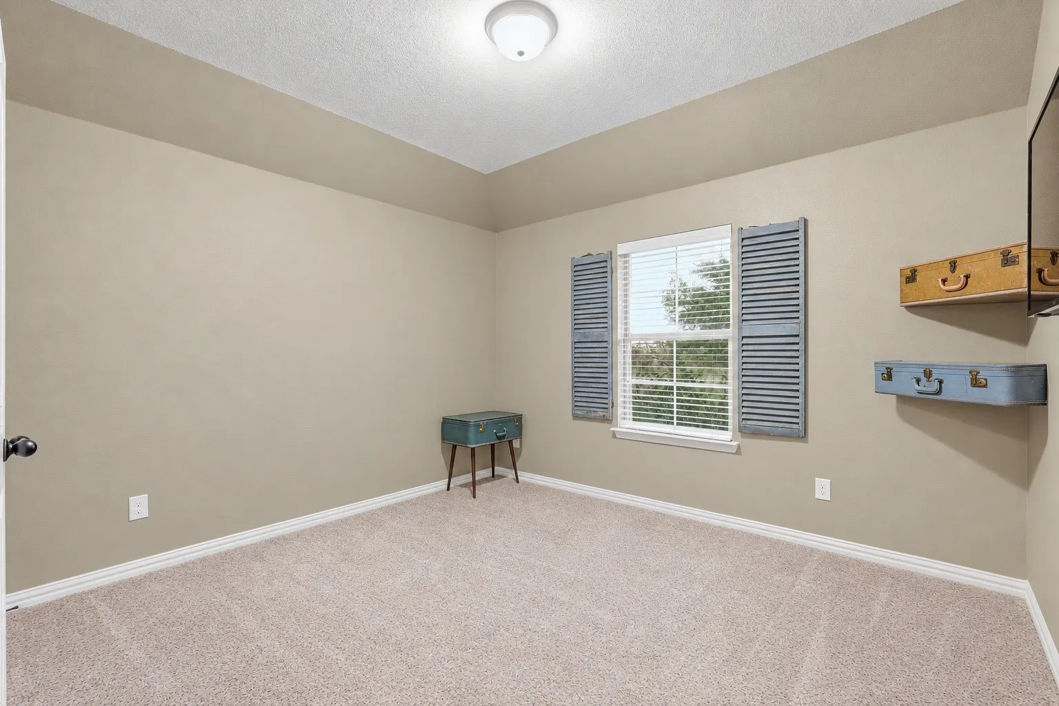 Recessed ceiling detail, neutral carpet, and a window with blinds