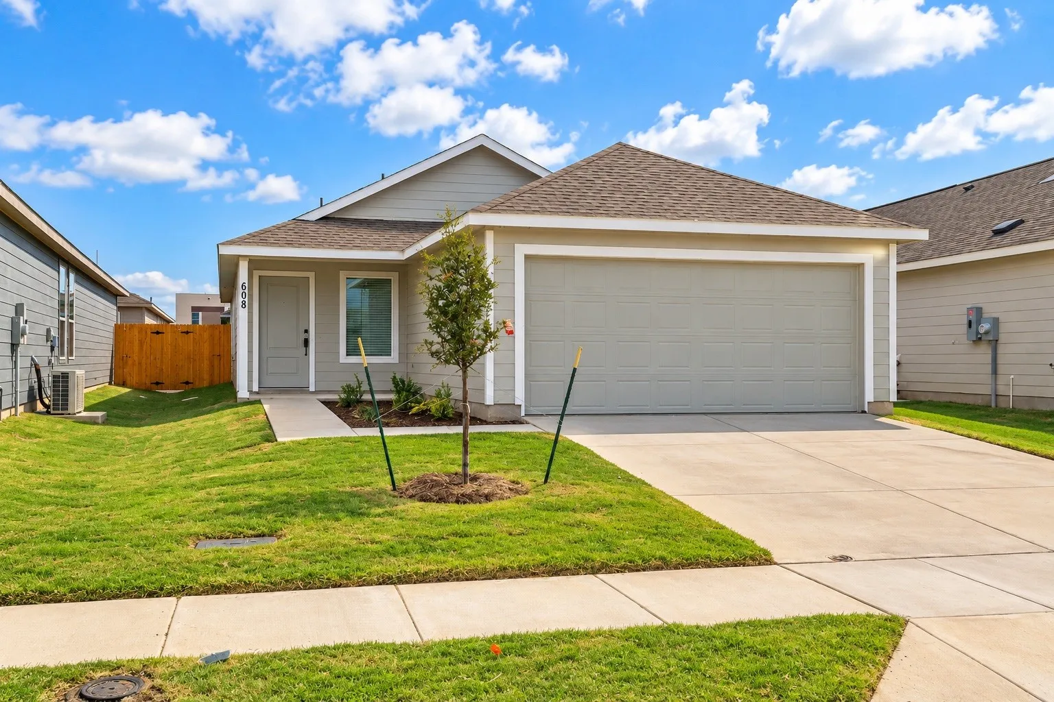 Single-story residence featuring a two-car garage, concrete driveway, and front walkway