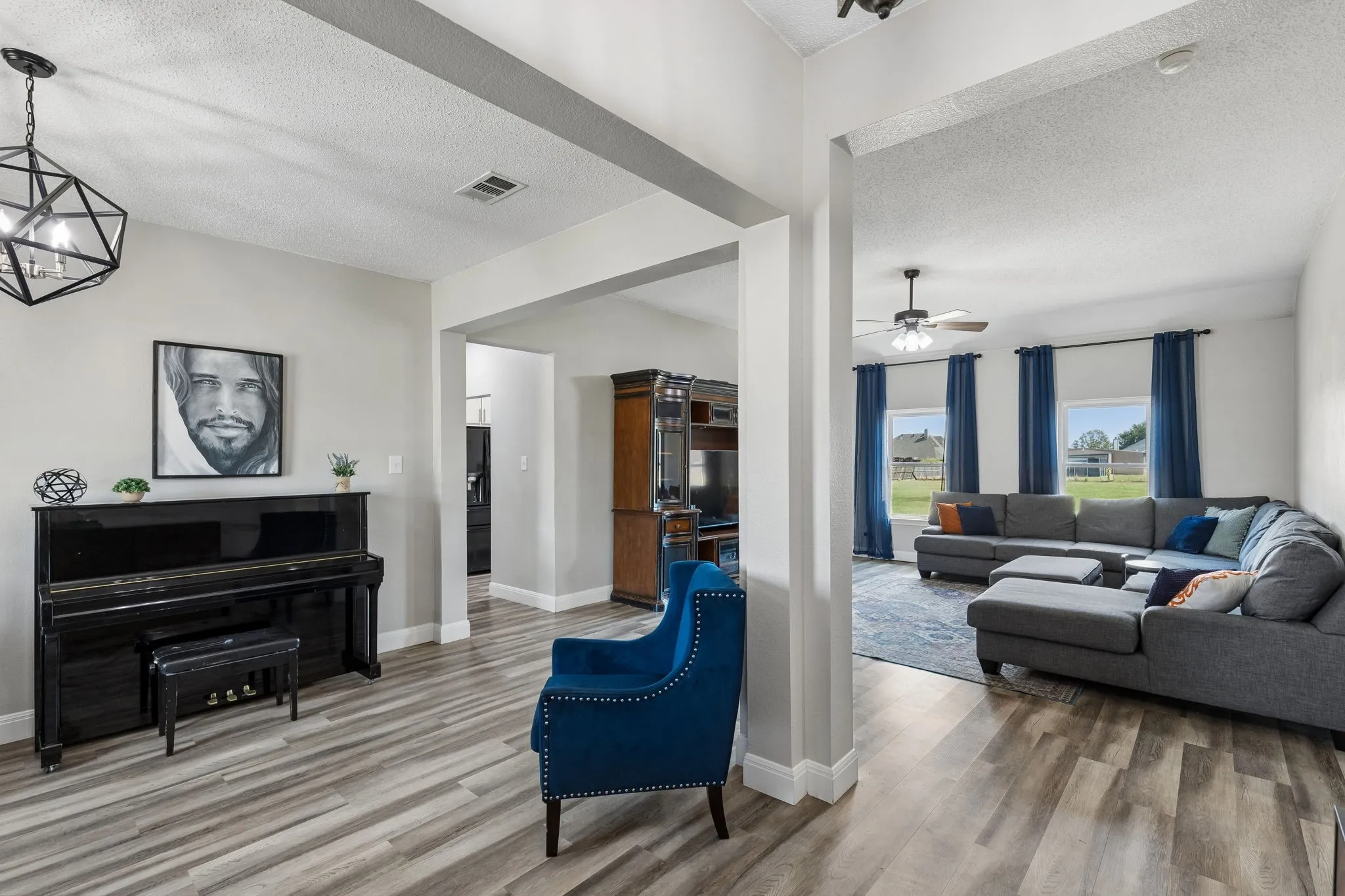Light-toned wood-finish flooring extends throughout, complemented by light gray wall tones