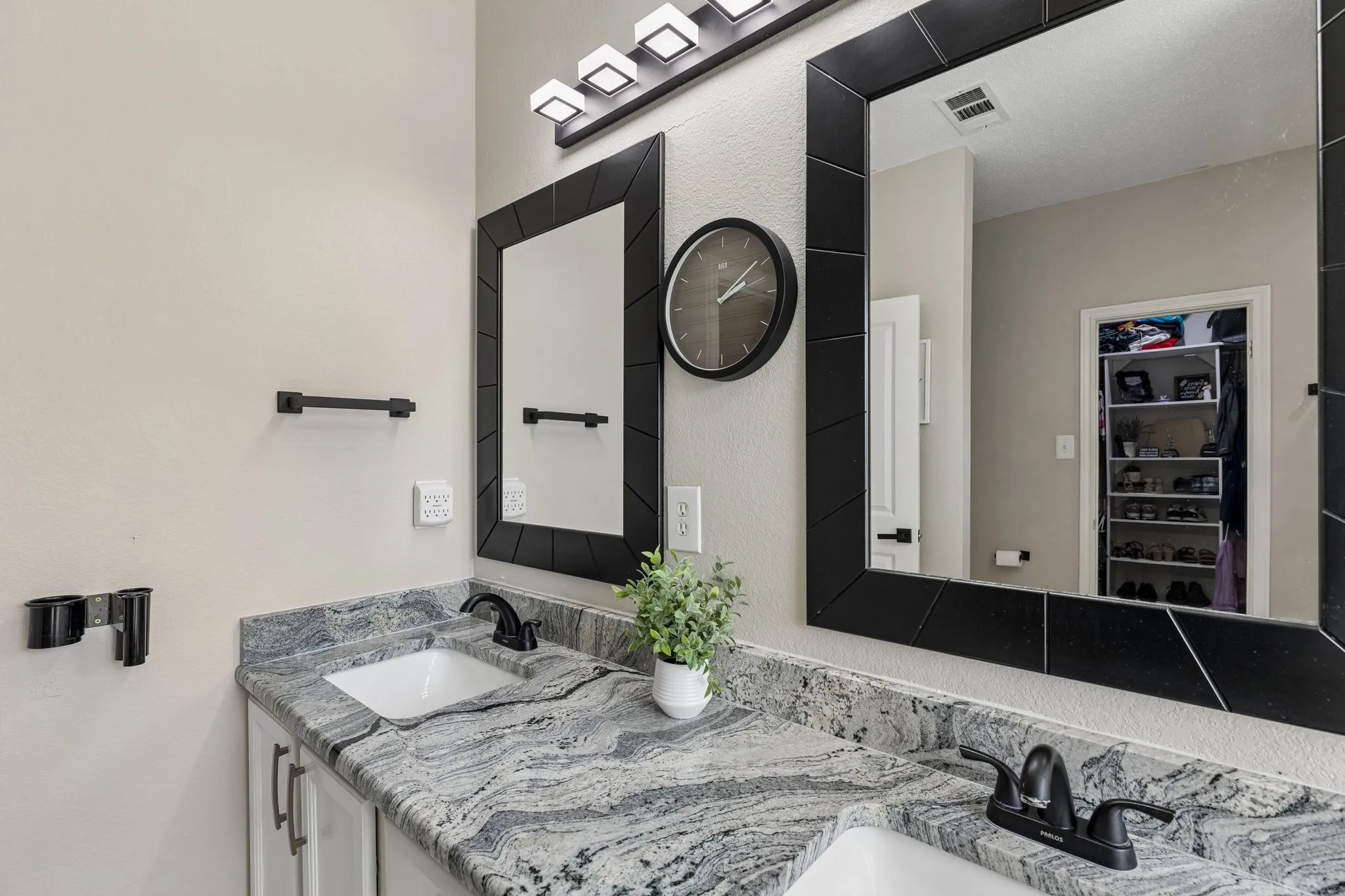 Dual rectangular undermount sinks set into a stone countertop