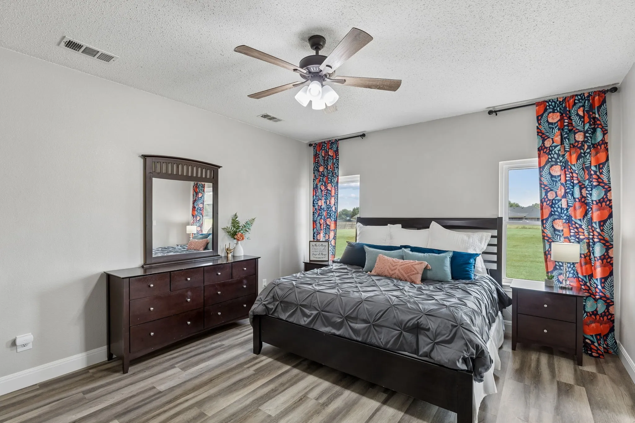 Recessed lighting, wood-finish flooring, ceiling fan, and multiple windows providing natural light