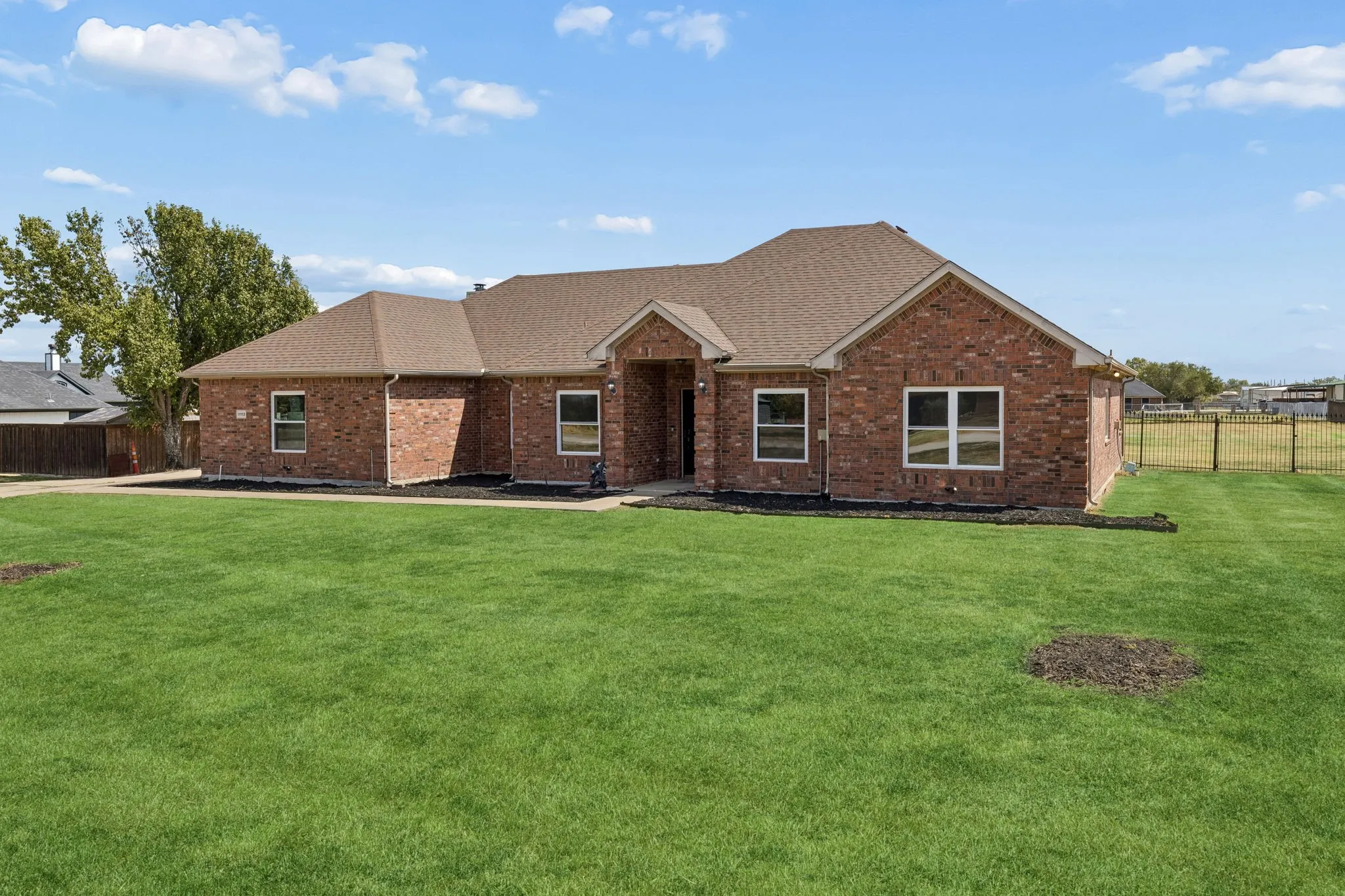 Brick exterior with a gabled roof and white window frames
