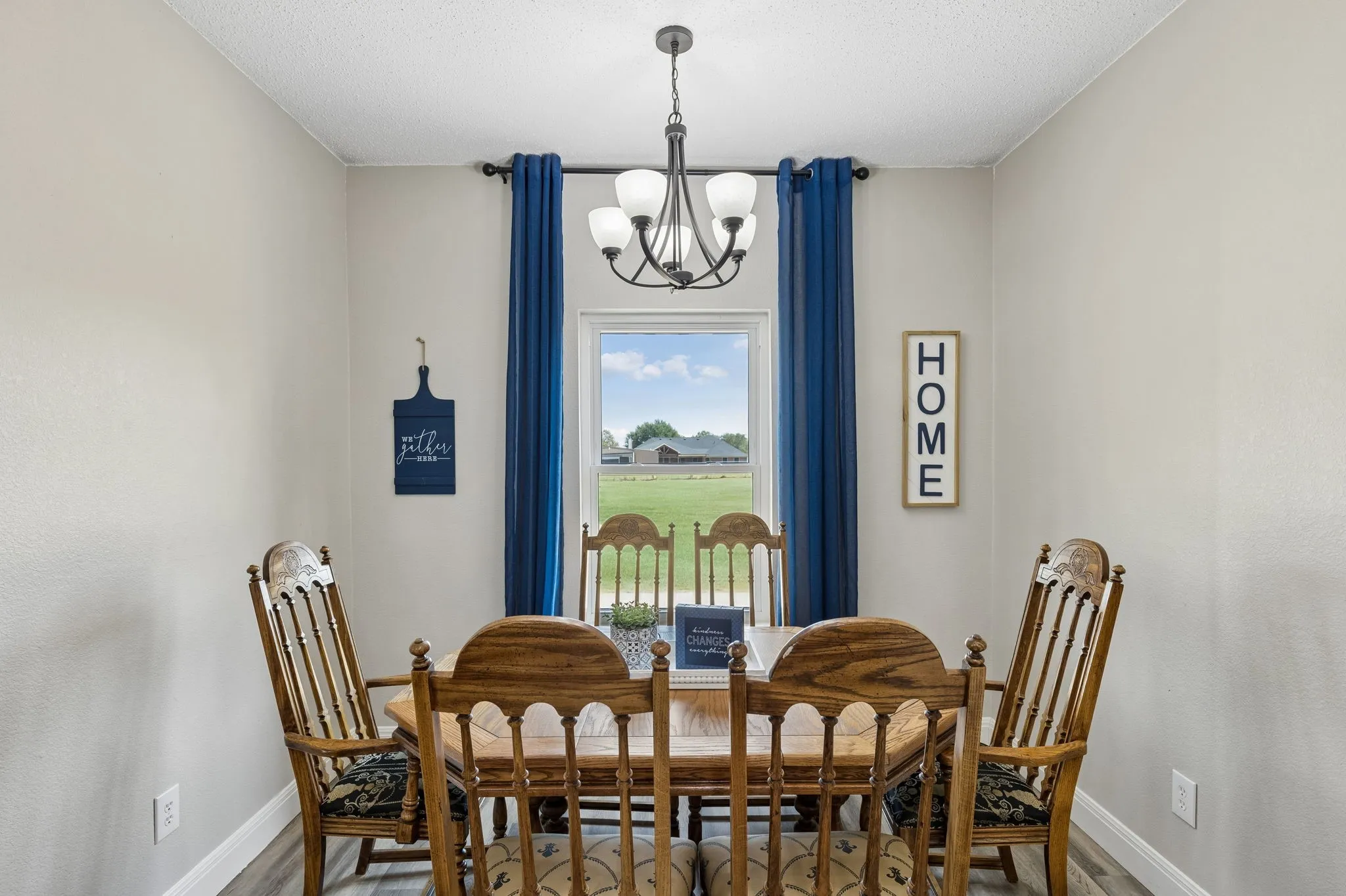 Window with outdoor scenery, recessed lighting, and wood-finish flooring