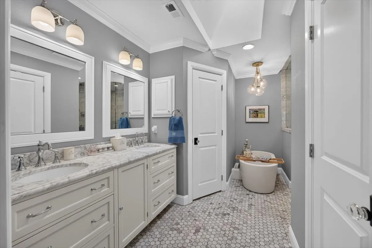 Marble countertops, marble tile floors, two sinks, soaking tub, walk in shower with 2 rain heads and 1 handheld, two walk in closets.