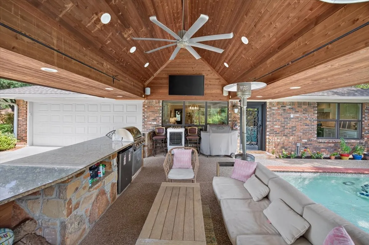 Outdoor Living Area. High Volume Fan, Granite Countertops, Built in Blaze gas grill, Wood burning fireplace with gas starter. Two Samsung TVs.