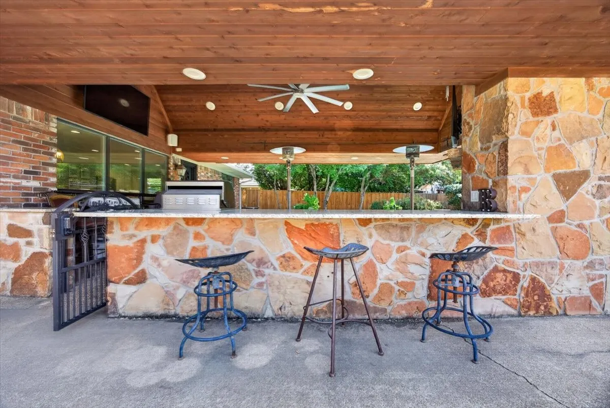 Granite countertops with stone. Overhanging bar for additional seating and serving space.
