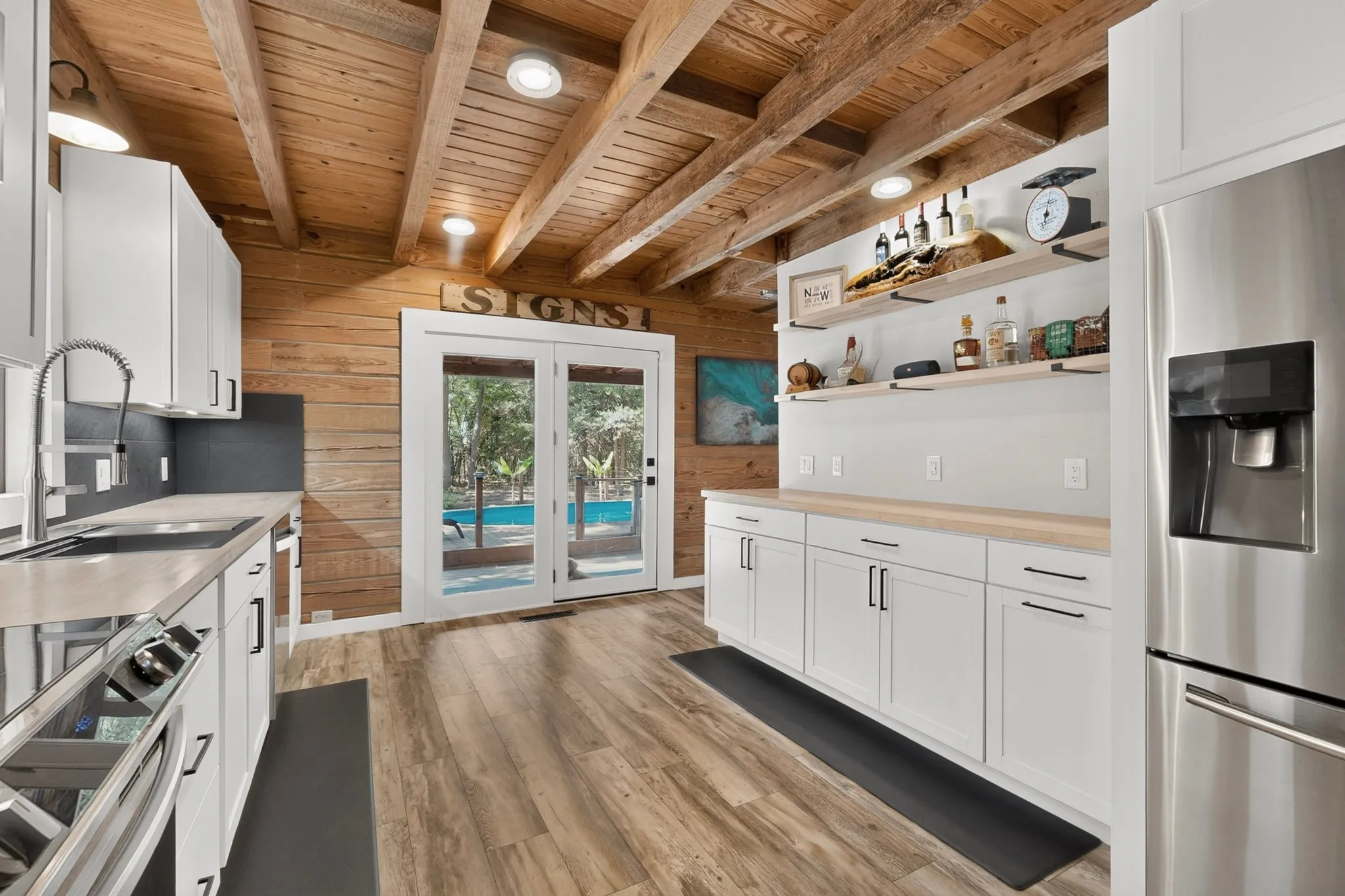 Wood ceiling beams and doors to the backyard patio