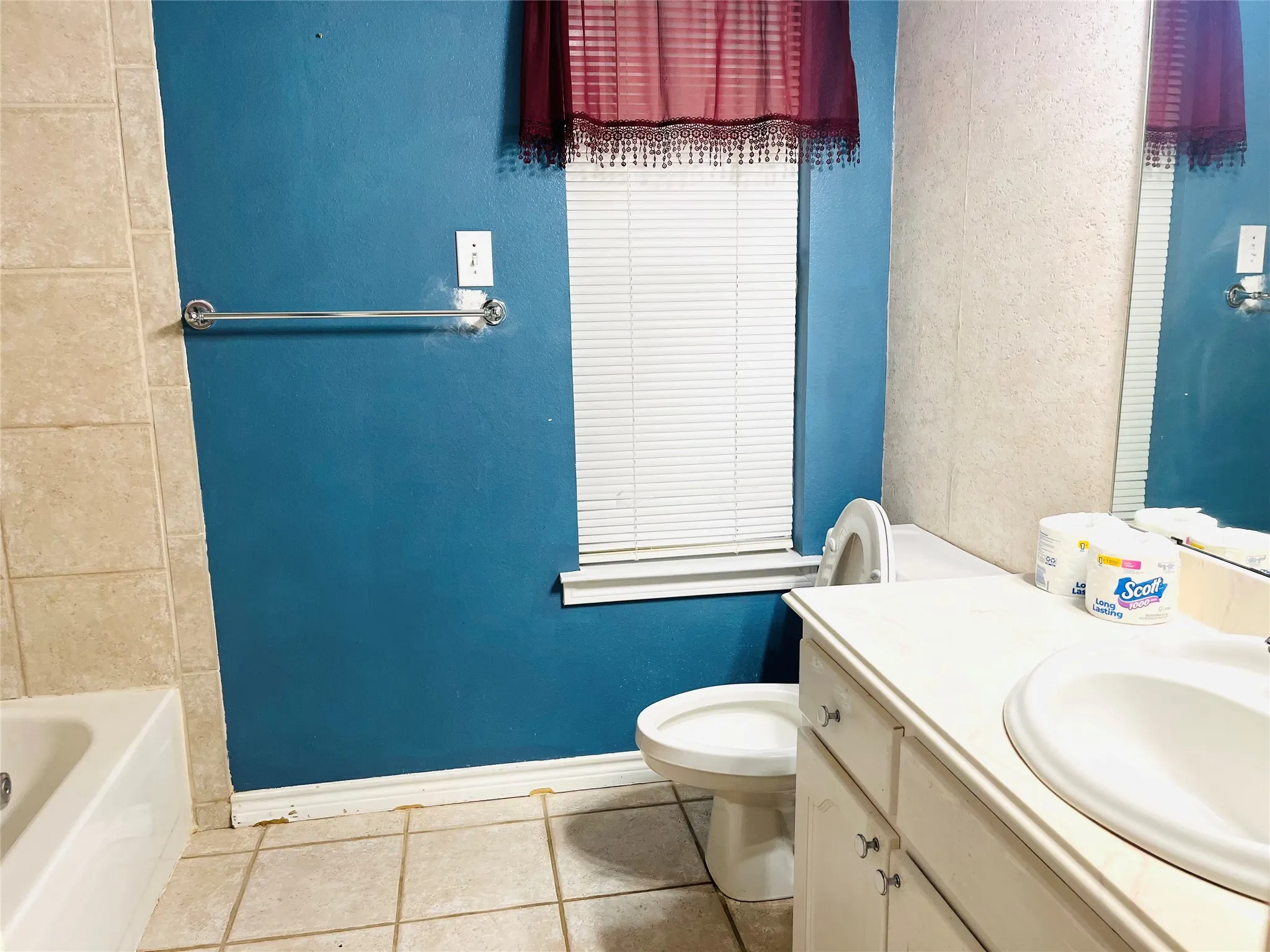 White vanity with an integrated sink and base cabinetry