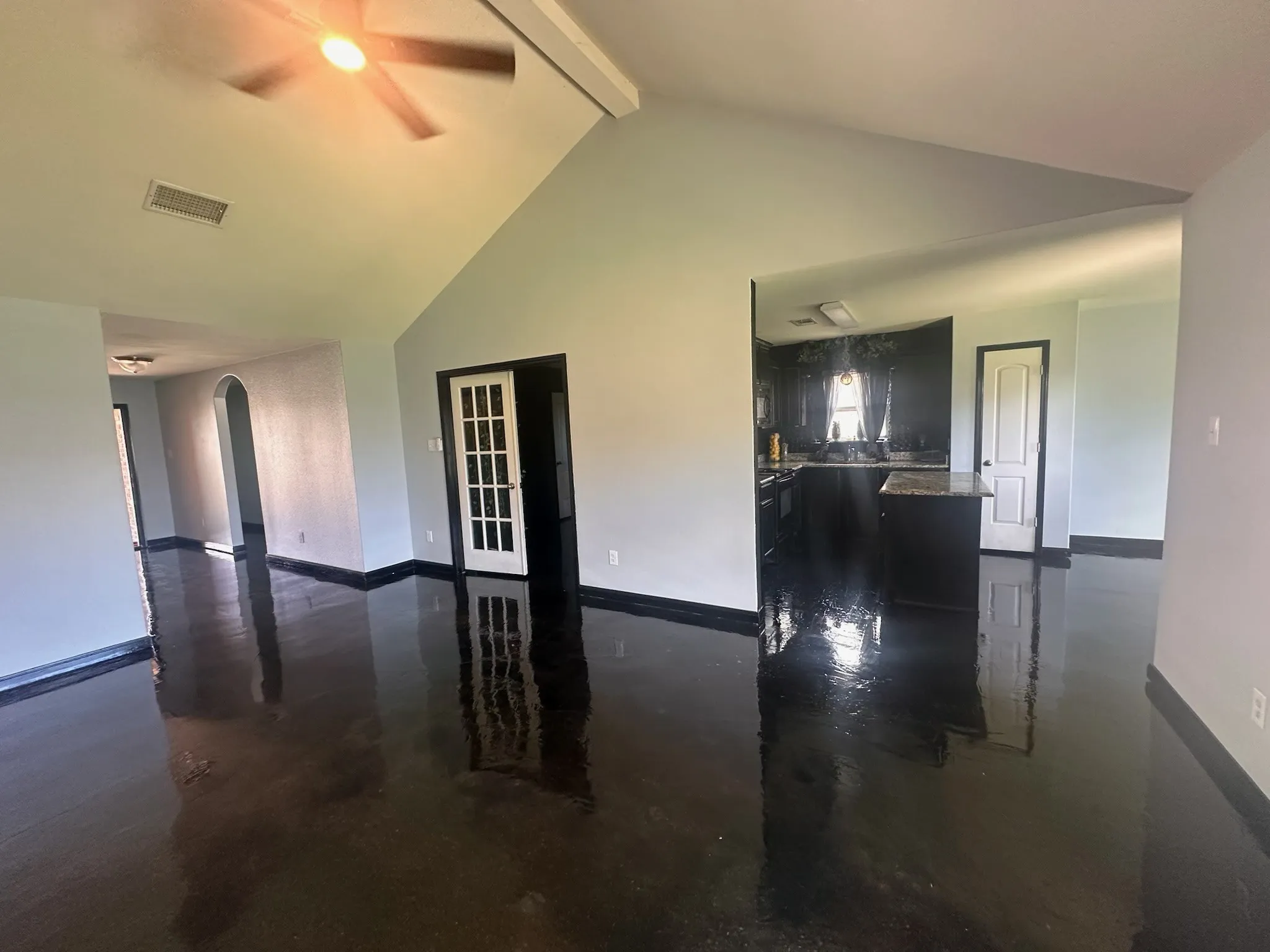 Family room with polished concrete floors in open concept living room.