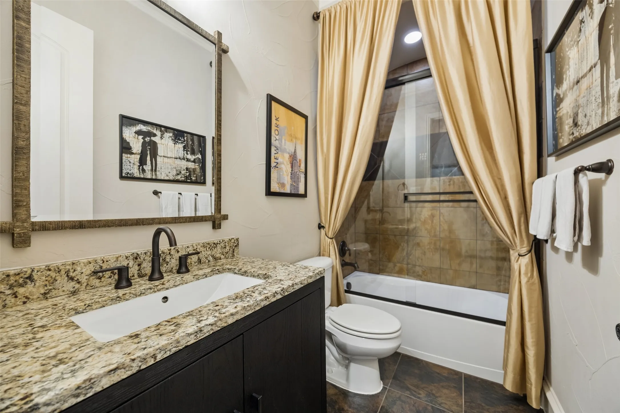 Full bathroom with tub/shower combo.