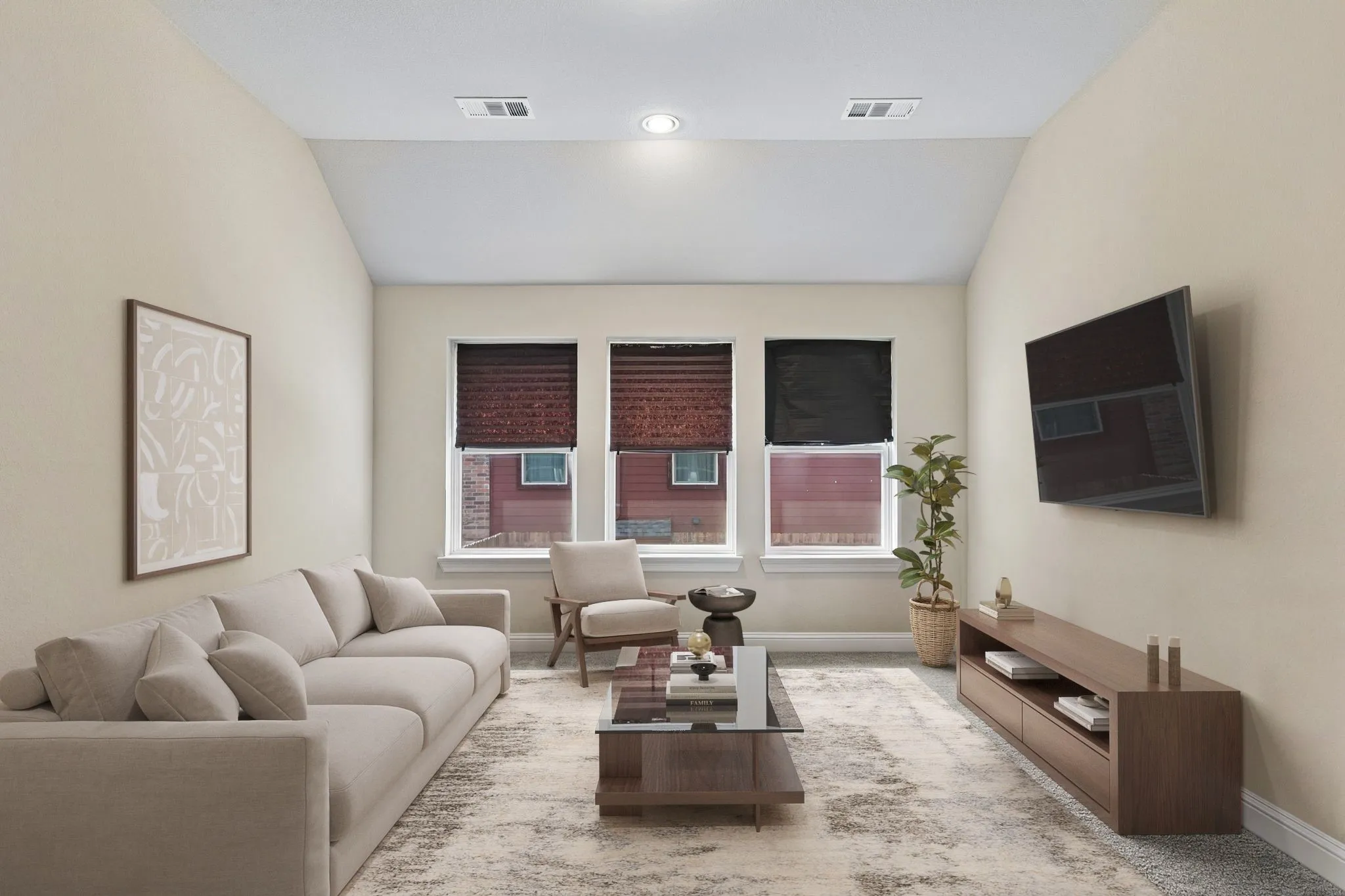 Vaulted ceiling with recessed lighting, three windows with blinds, and a wall-mounted display