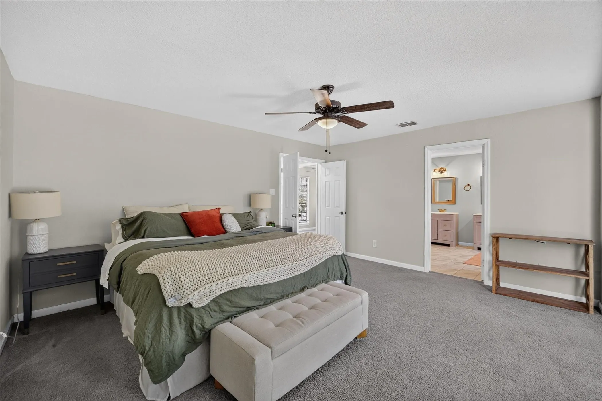 Neutral wall tones and gray carpeting