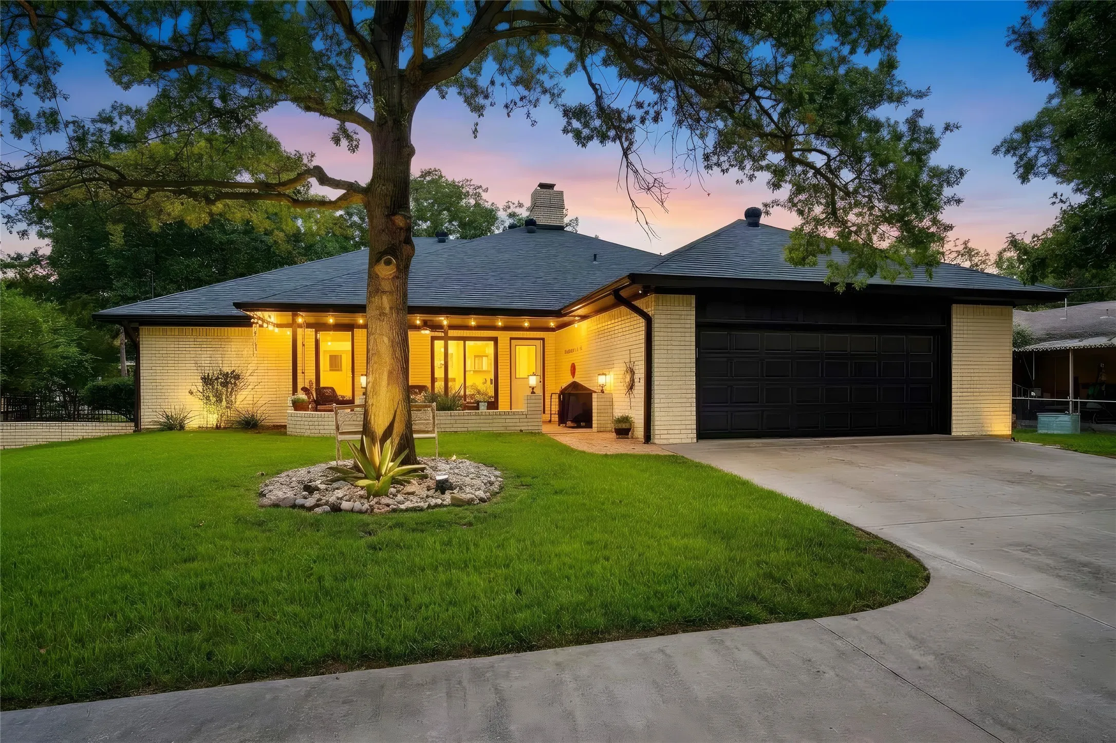 Brick exterior with dark trim and a black garage door
