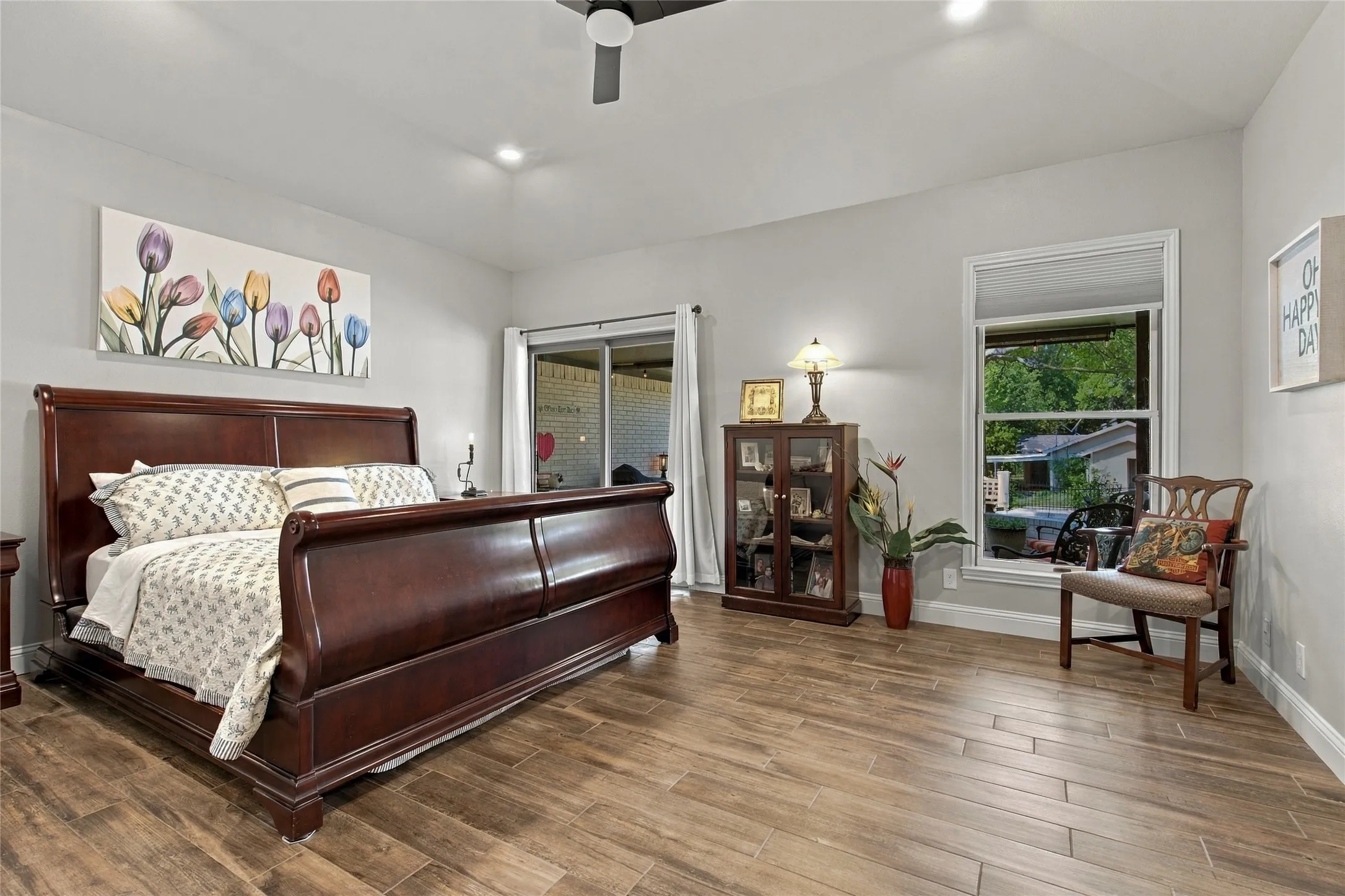 Light gray walls, wood-finish flooring, recessed ceiling lighting, and a ceiling fan