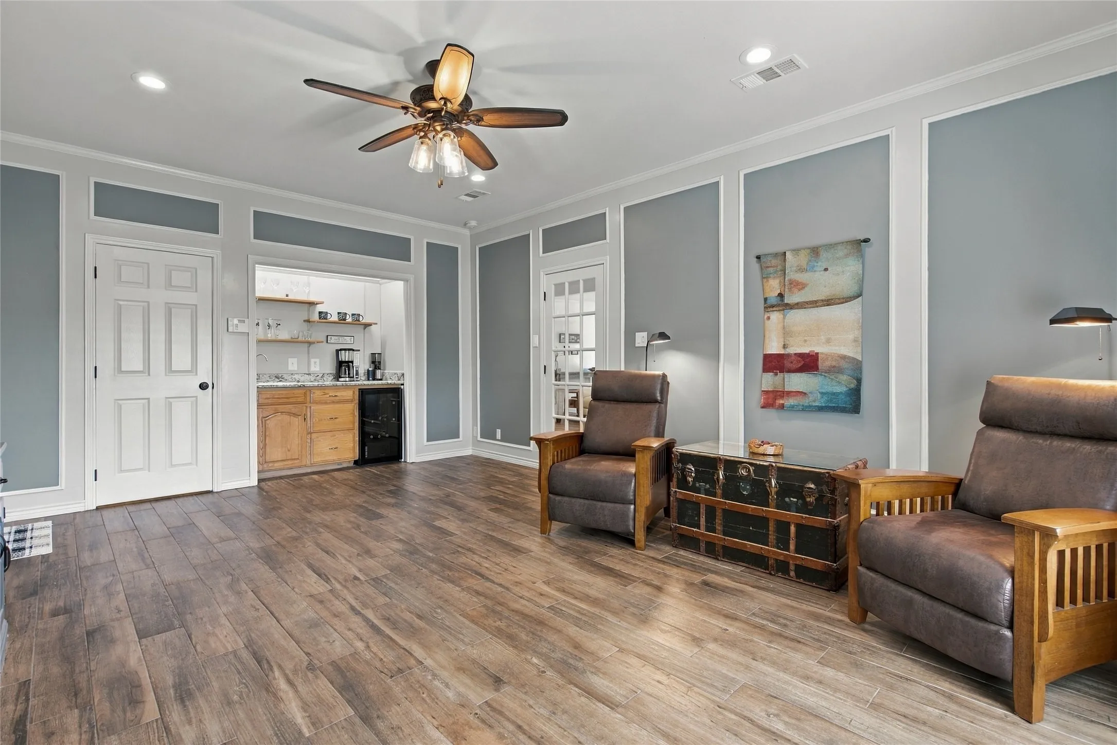 Wood-finish flooring, recessed lighting, and crown molding