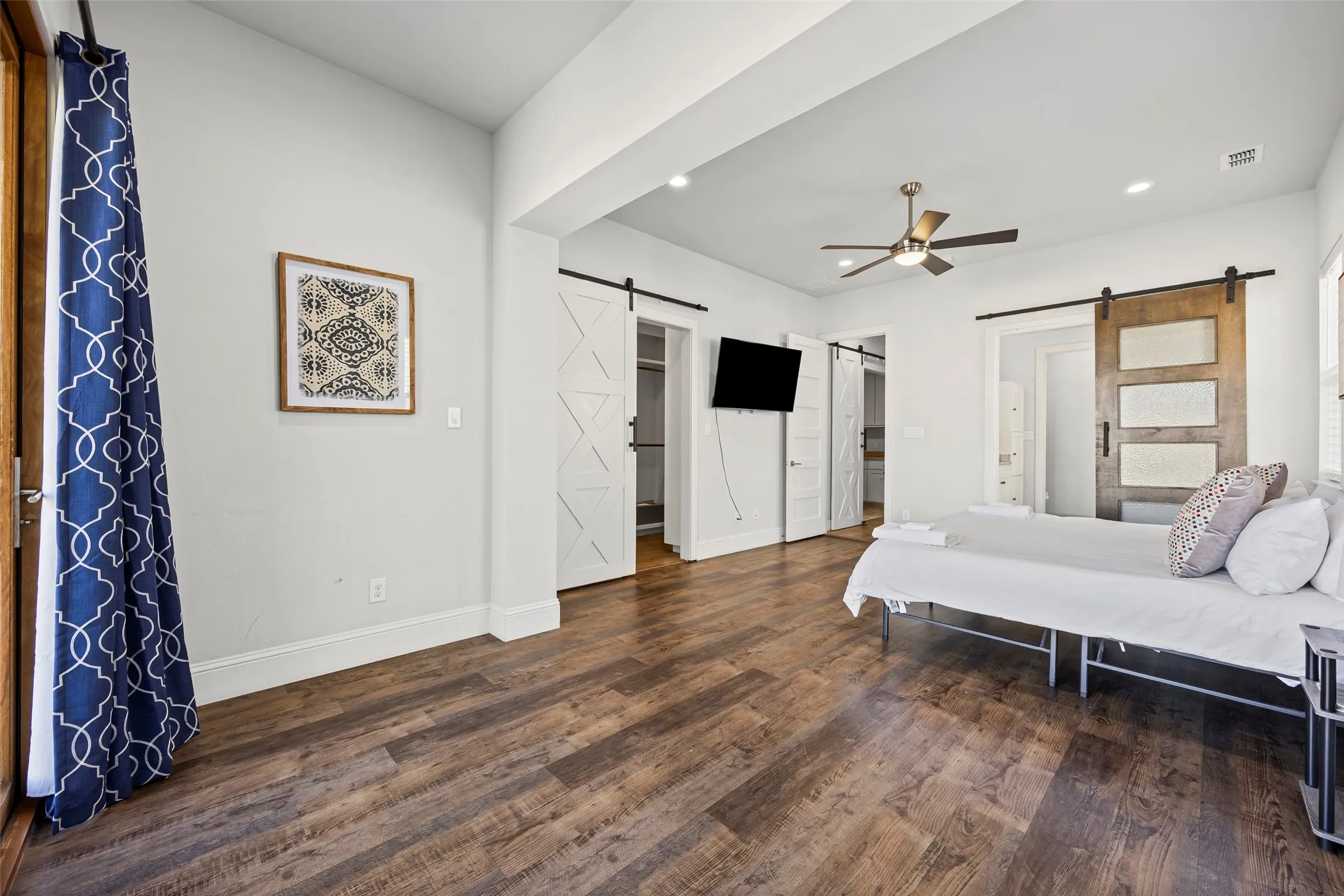 The massive primary suite features a sitting room with a door to the balcony, en-suite bath and huge closet with built-in shelving