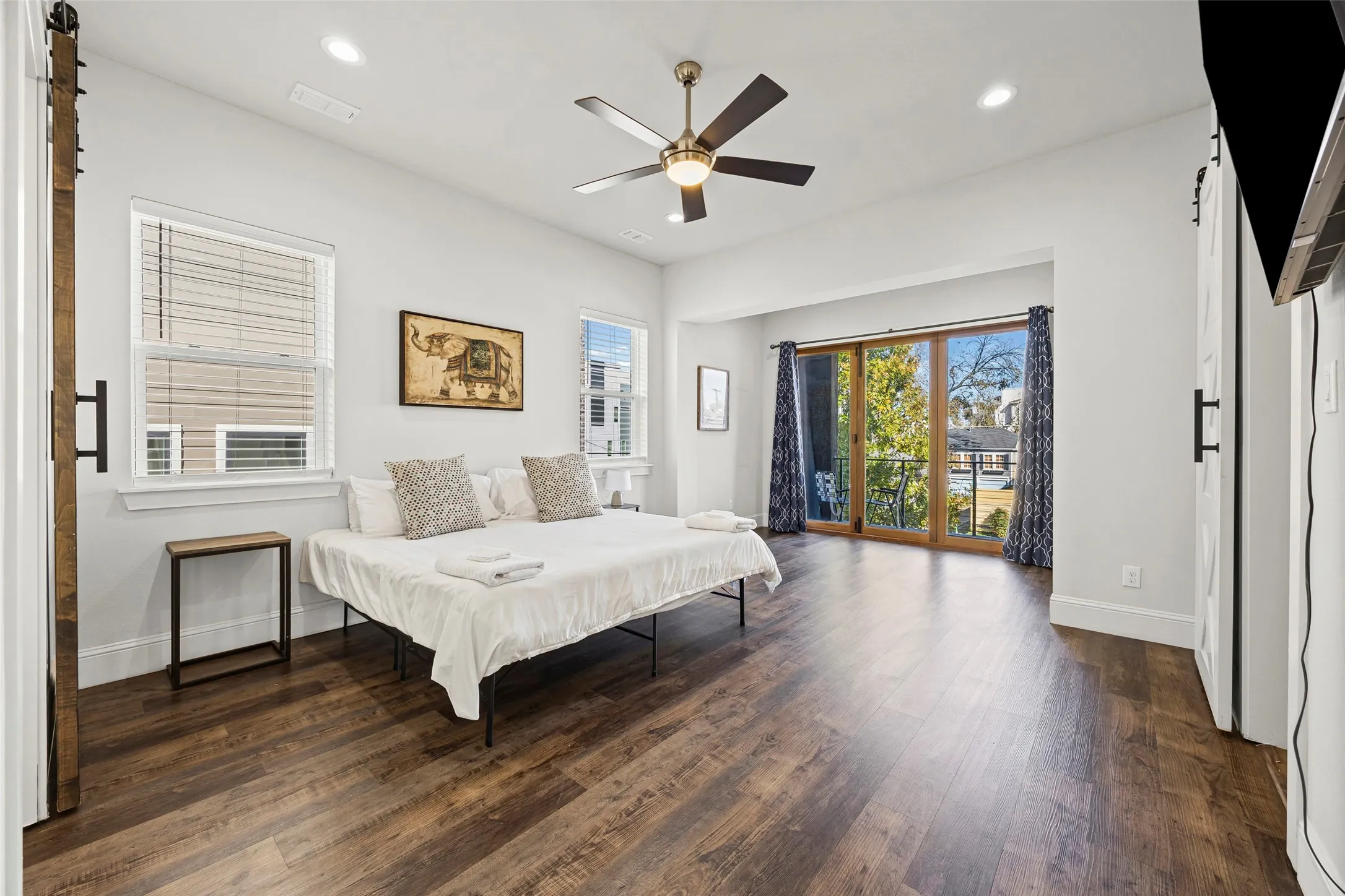 The massive primary suite features a sitting room with a door to the balcony, en-suite bath and huge closet with built-in shelving