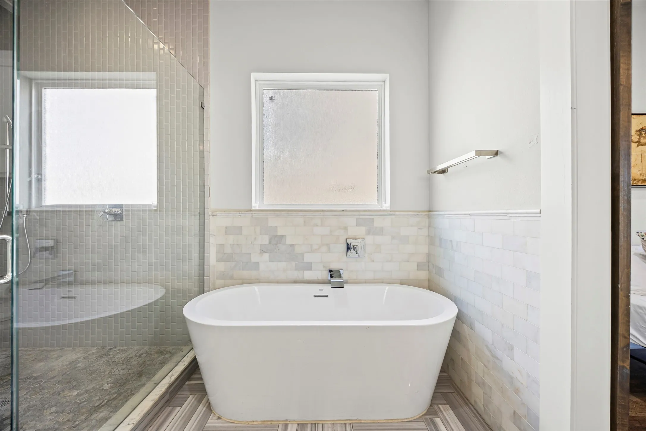 Primary bathroom features free-standing tub, shower and double sinks