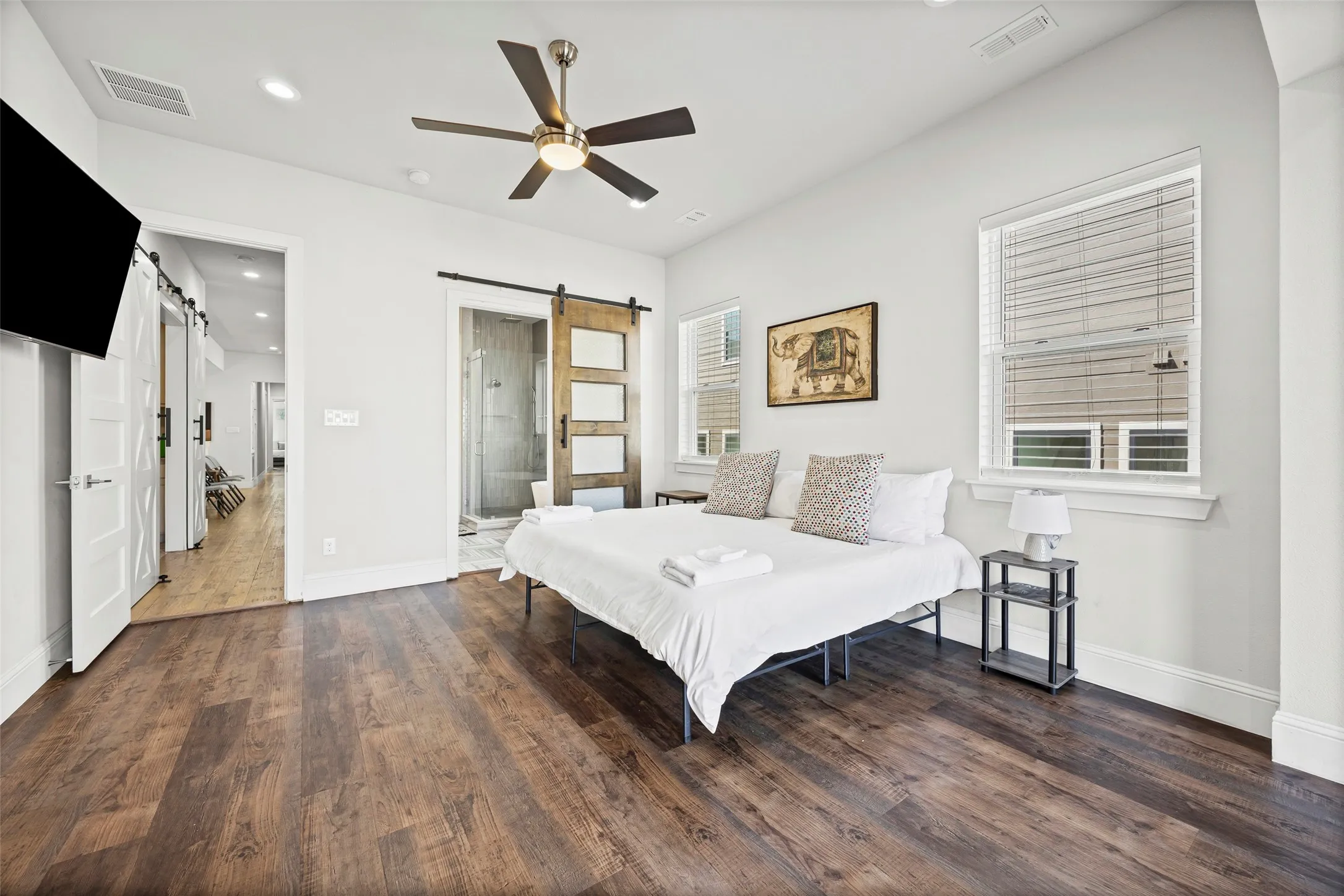 The massive primary suite features a sitting room with a door to the balcony, en-suite bath and huge closet with built-in shelving