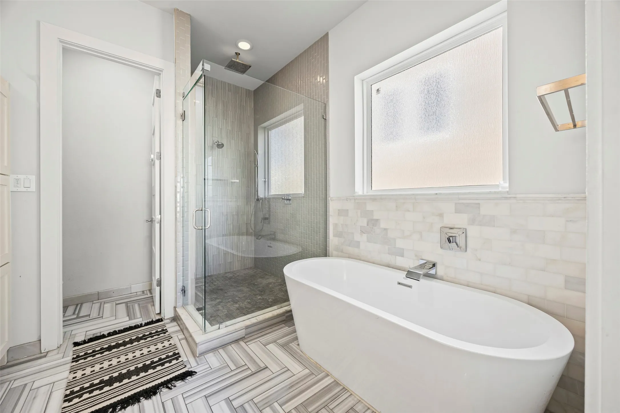 Primary bathroom features free-standing tub, shower and double sinks