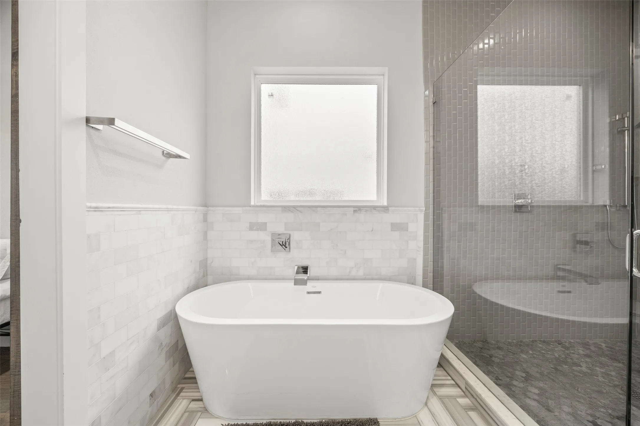 Primary bathroom features free-standing tub, shower and double sinks