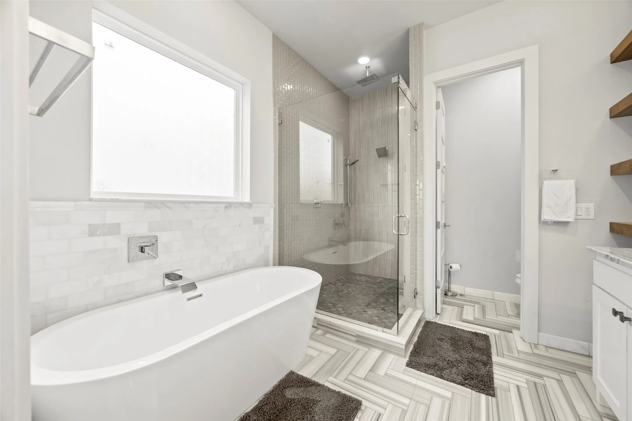 Primary bathroom features free-standing tub, shower and double sinks