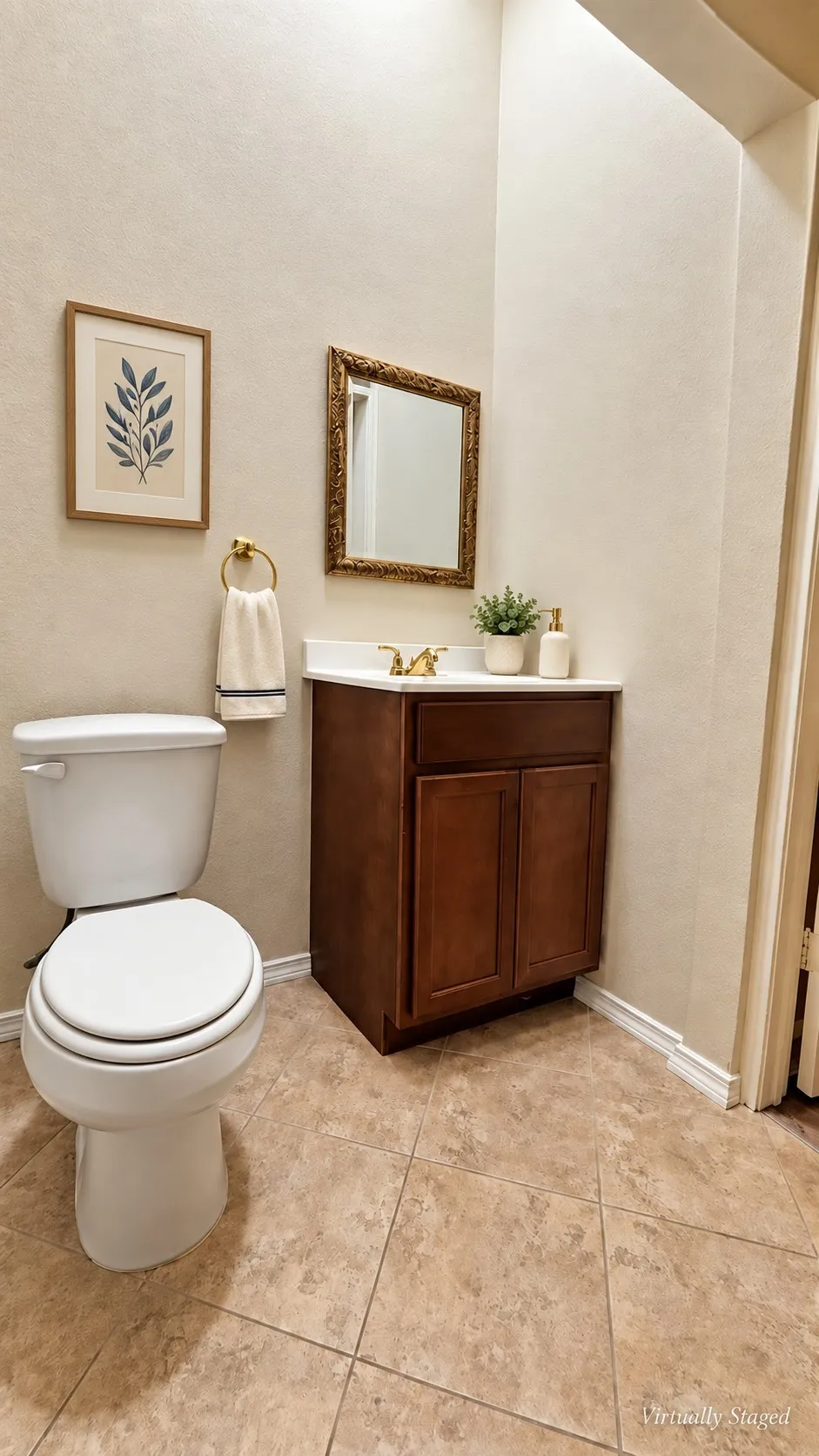 Vanity with a white countertop and gold-toned faucet, complemented by a decorative mirror