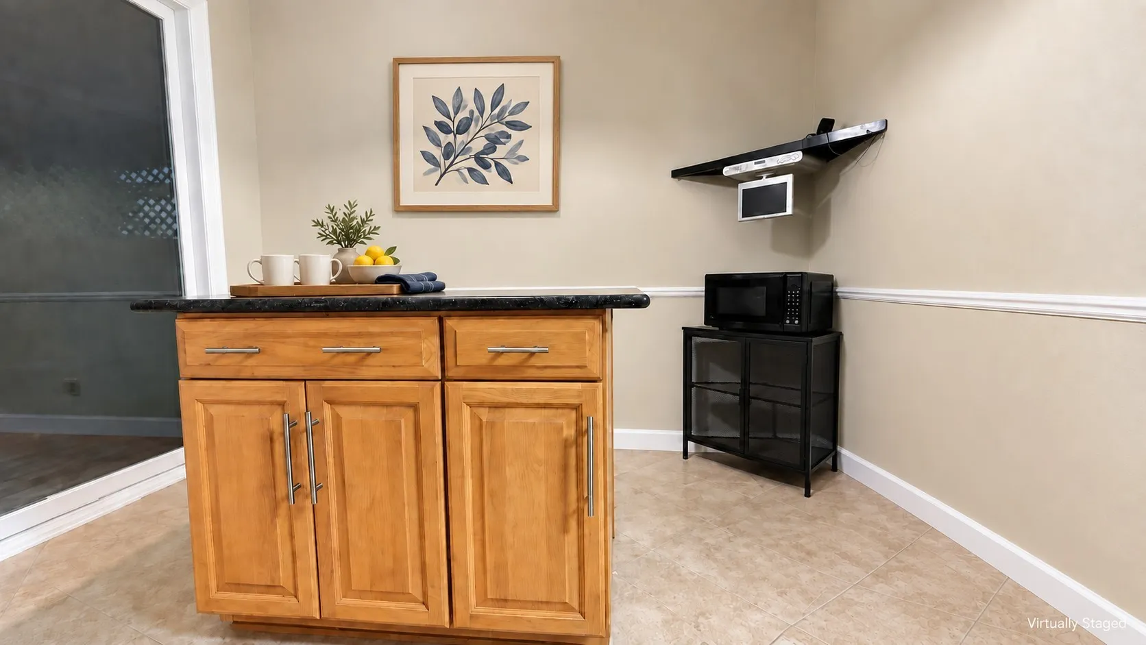 Wood-finish island cabinetry with a dark countertop, tile flooring, and a sliding glass door
