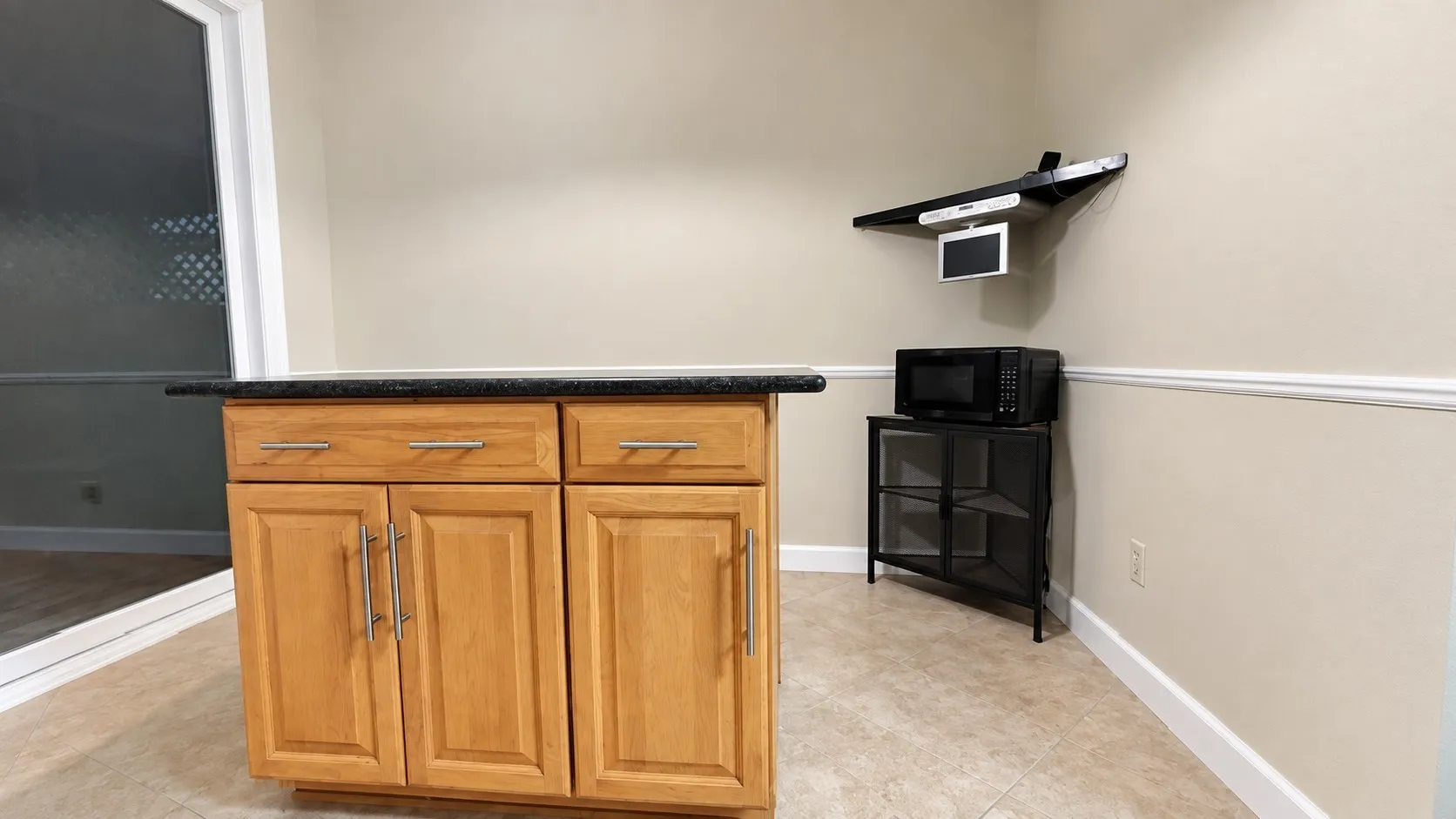 with a granite cabinet, Microwave and Smal player