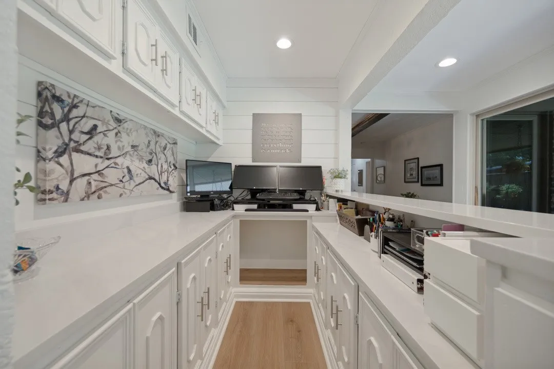 Office with 10' of white cabinets x 2 sides + overhead cabinets + quartz countertop. Could also be a serving area or dry bar.