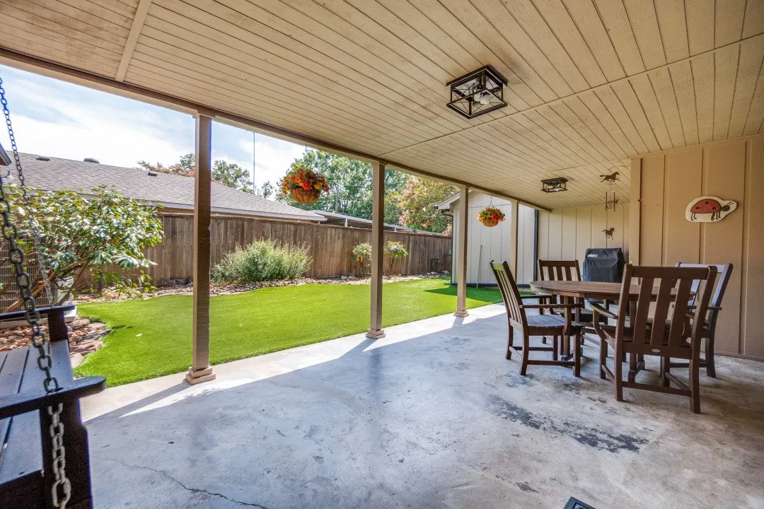 Covered patio is 31 x 12 ft, covered access to the garage, has a metal roof, and offers year-round enjoyment since it is enclosed on 3 sides.