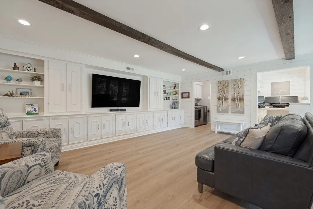 Family Room is spacious, has luxury vinyl plank flooring, canned lights, 20' wall of cabinets, & an 8'x6' extra storage room off the Family Room.