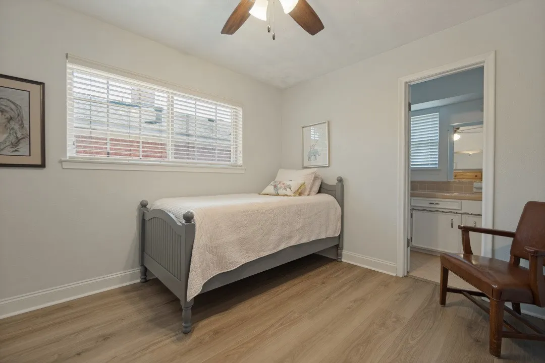 Bedroom 3 has a ceiling fan, LVP flooring, walk-in closet, & is adjacent to the 2nd bathroom.