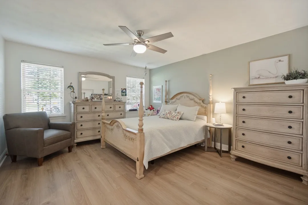 Primary Bedroom has a ceiling fan, nice windows, walk-in closet, LVP floor, & ensuite bath.
