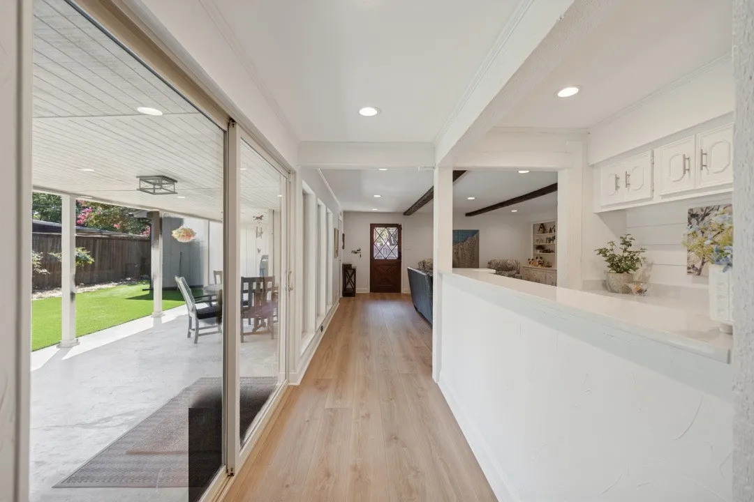 Wall of floor-to-ceiling windows and slider door = 17 ft. long and has morning sun.