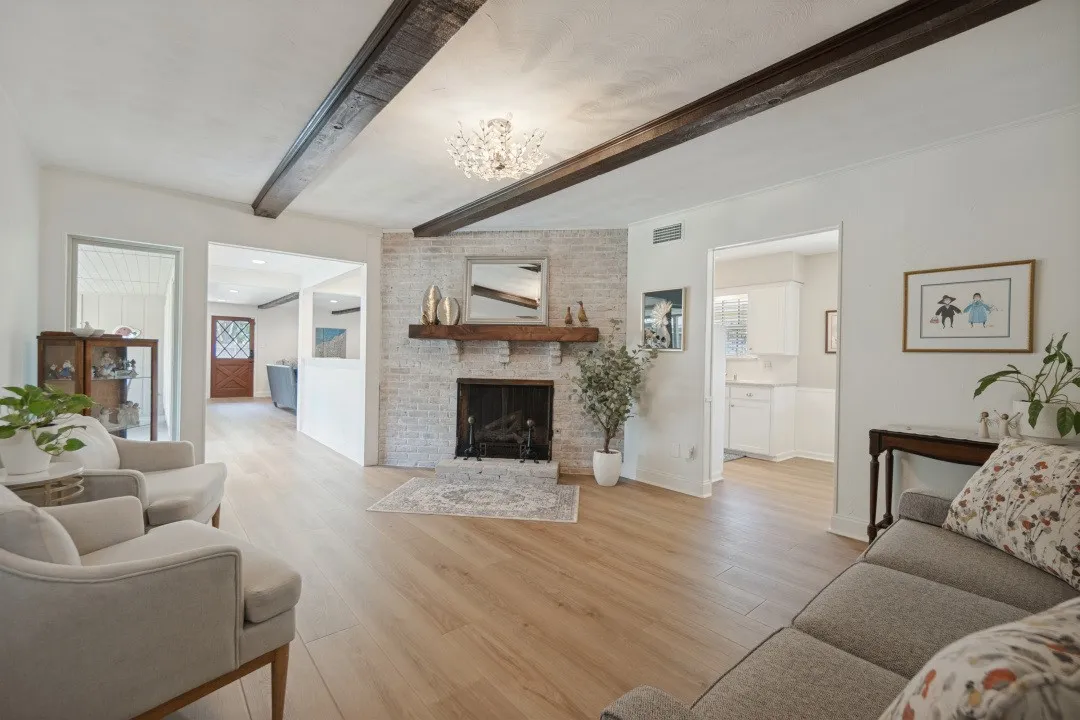 Focal Point of the Living Room is the brick fireplace with gas logs & a raised hearth.