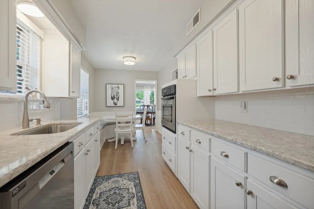 Kitchen is galley style and opens to the breakfast area and on to the Dining Room. Breakfast area has cozy built-in seating area.