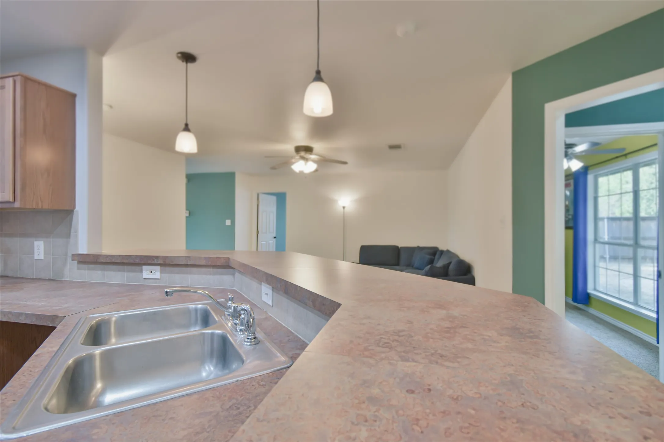 Dual-basin stainless steel sink with a chrome faucet, set into a composite countertop