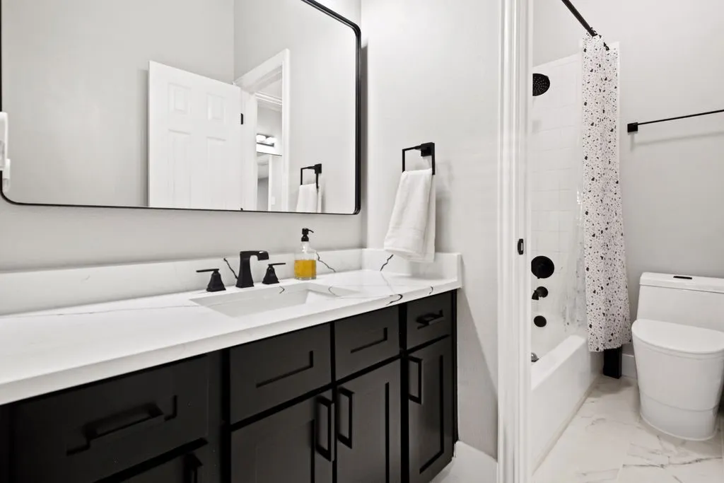 White countertop with integrated sink and matte black faucet