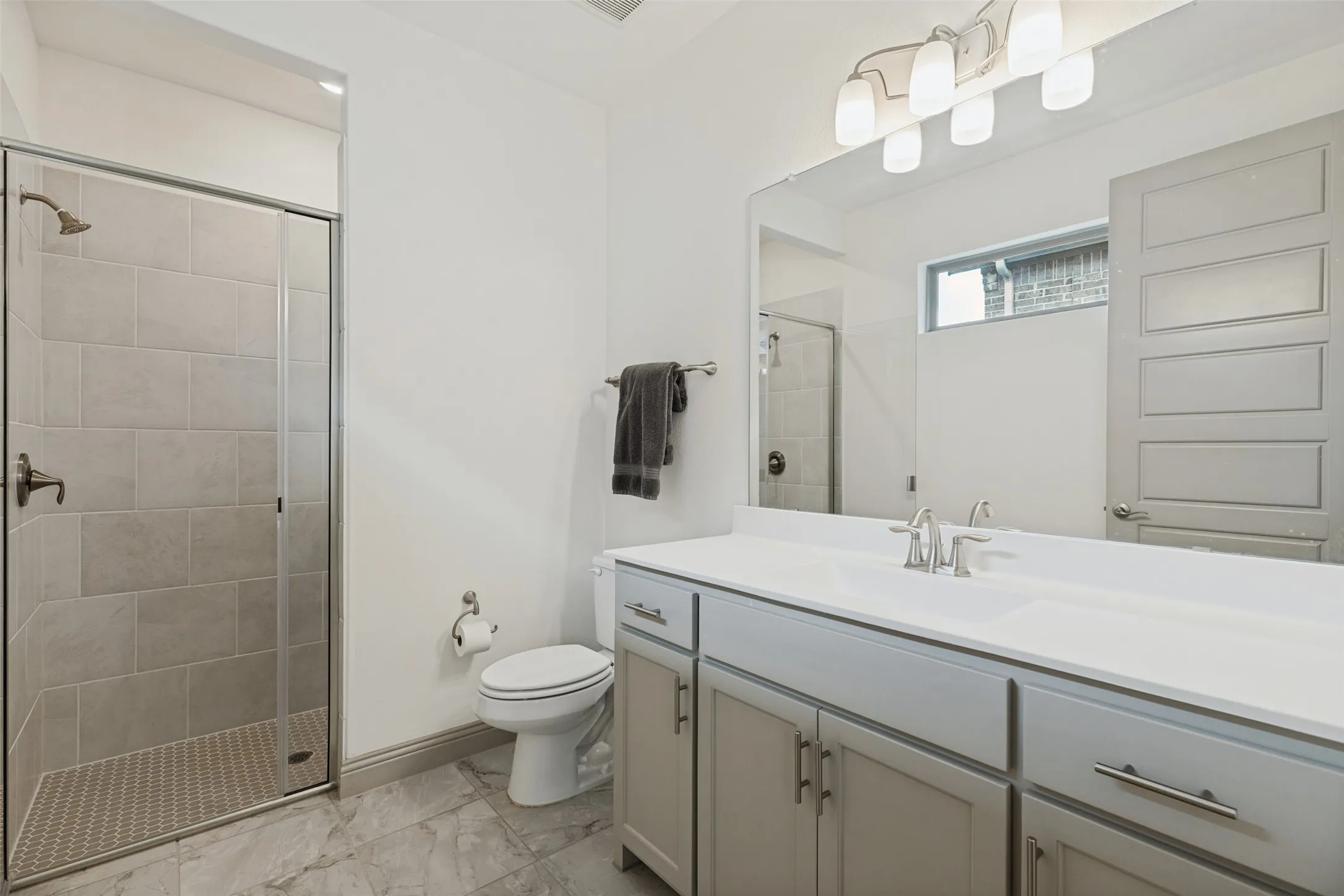 Ensuite bath in guest suite with large shower, quartz counters