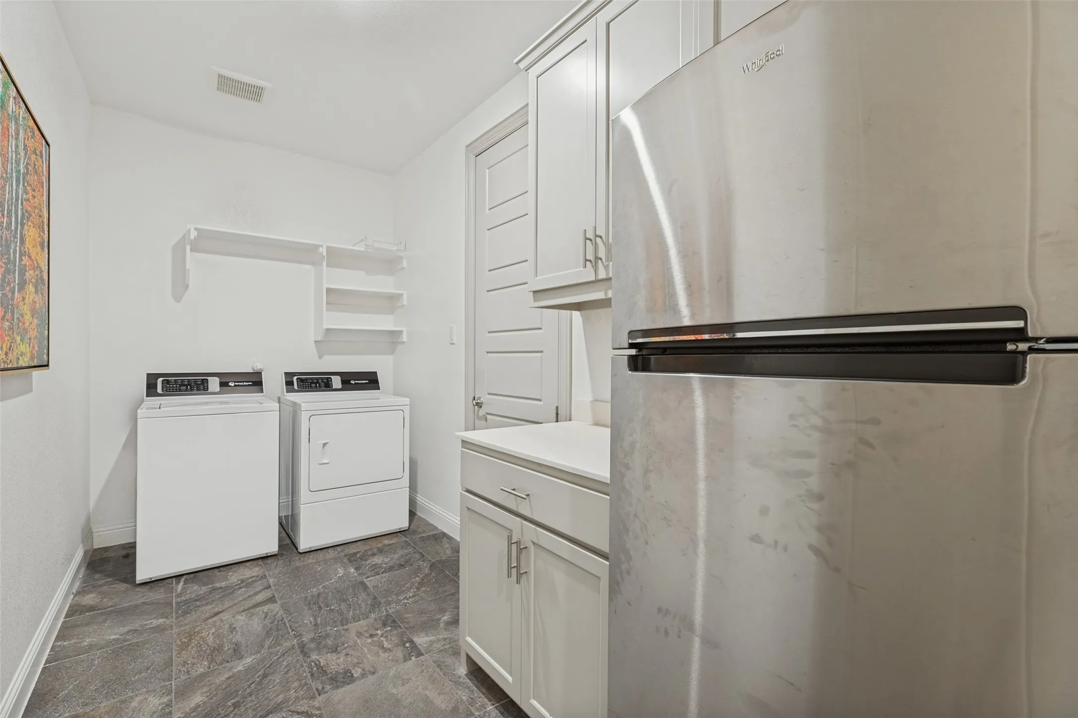 Large utility with access off the master closet, built in cabinets and room for a refrigerator
