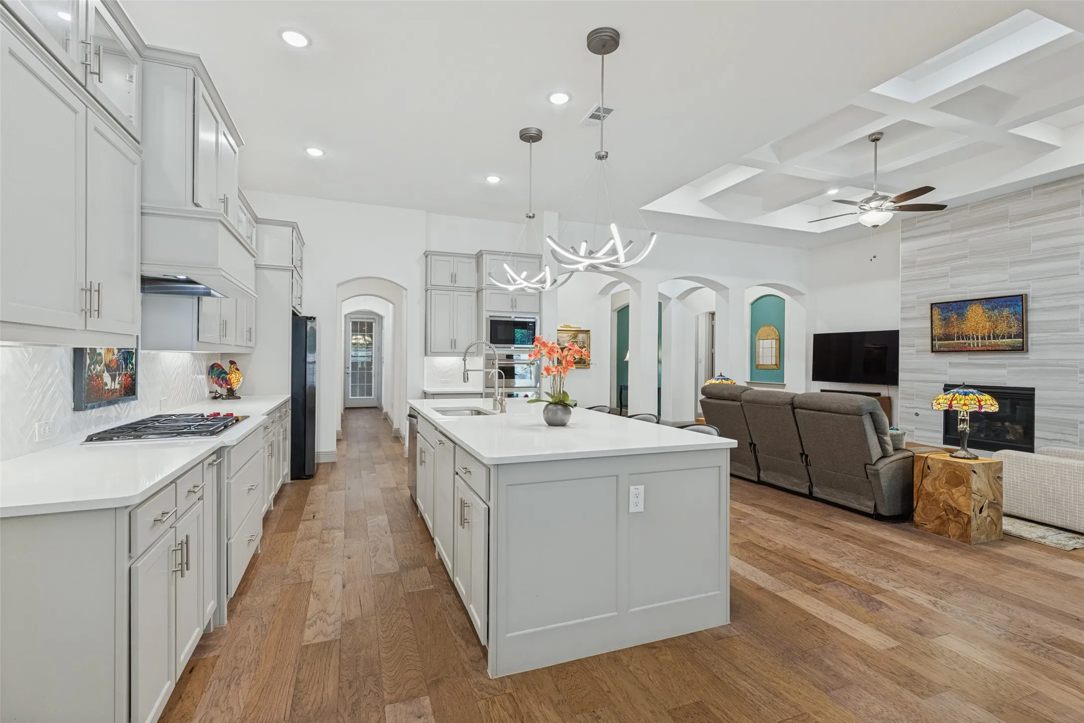 Custom lighting added in kitchen, hardwood floors throughout, quartz counters, designer details throughout