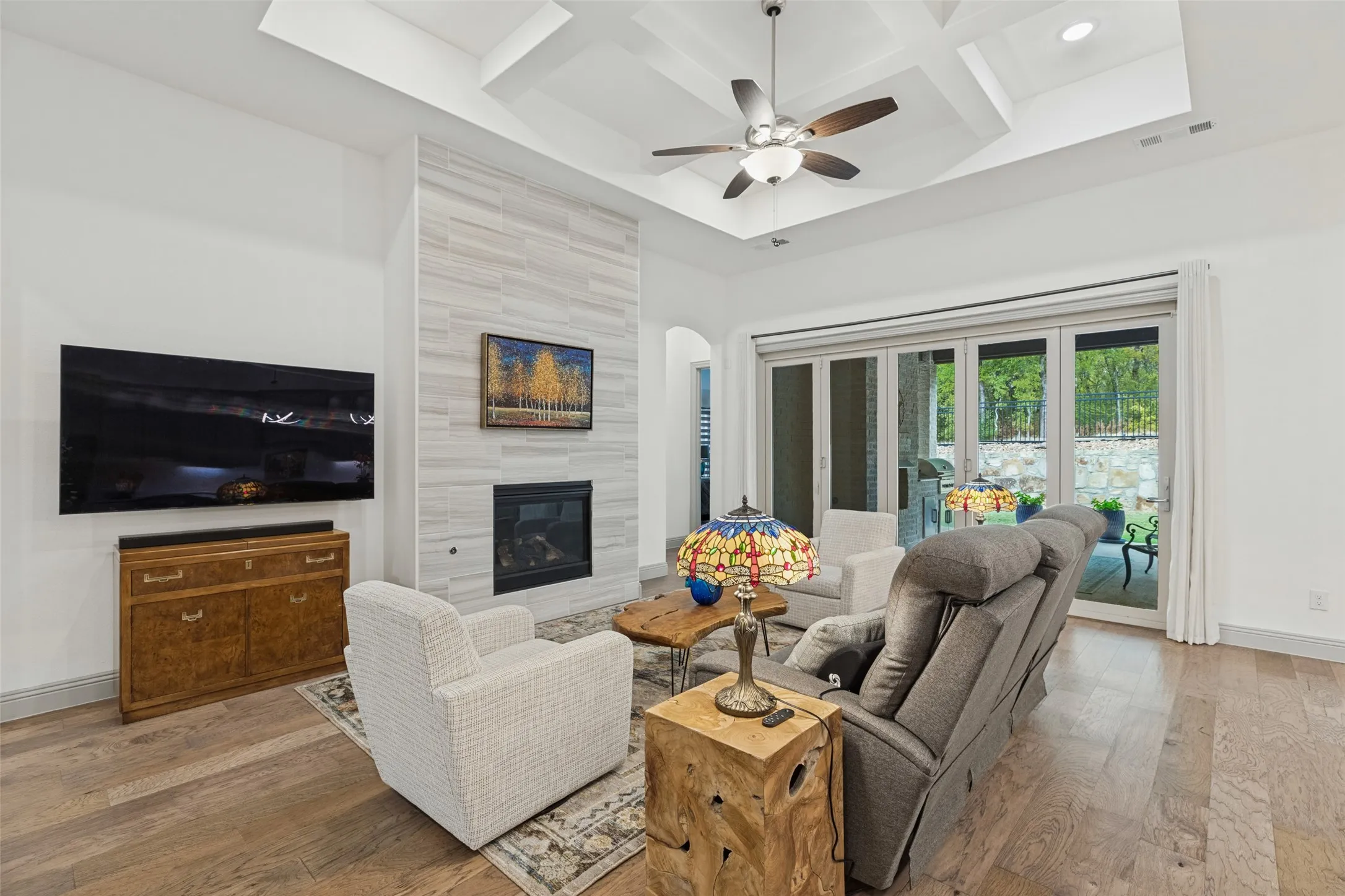 Open floorplan with gas fireplace and bi-fold doors that open to enjoy indoor/outdoor living!