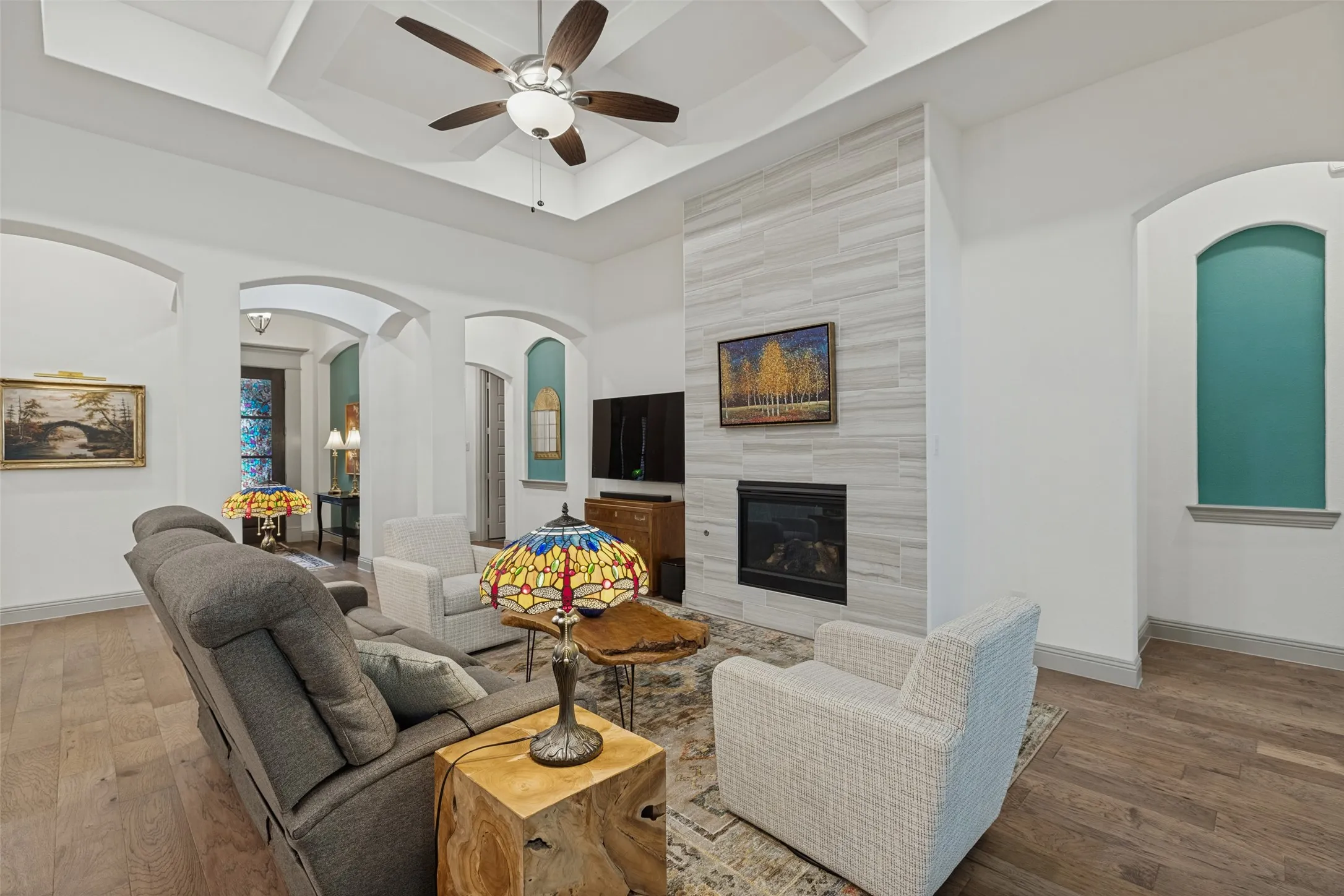 View of the open floorplan toward front entry showing all of the beautiful architectural details and hardwood floors