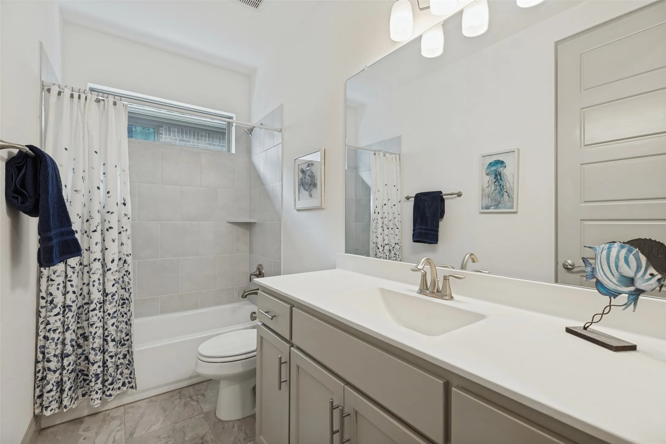 Large bath with quartz counters shared by two bedrooms